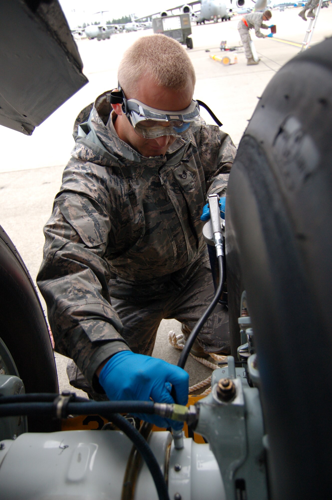 Staff Sgt. David Gregg, 319th Aircraft Maintenance Squadron, greases the axles of a KC-135 in preparation for an inspection during the 2009 Air Mobility RODEO at McChord AFB, Wash.   (U.S. Air Force photo/Tech. Sgt. Amanda Callahan)
