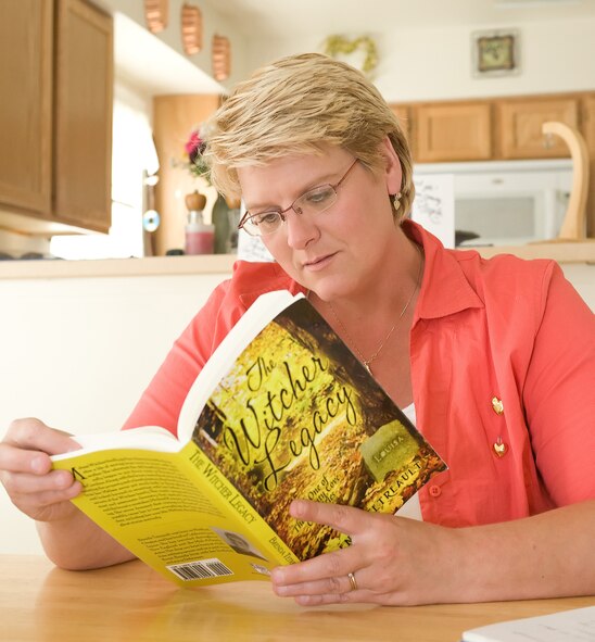 "I wanted to see my book off the pages of my notebook and computer screen. I wanted to hold the book and hear the sound of the pages turning. I hope that I'm able to bring some of the magic that reading gives me to others," said Mrs. Tetreault. (U.S. Air Force photo/Jason Minto) 