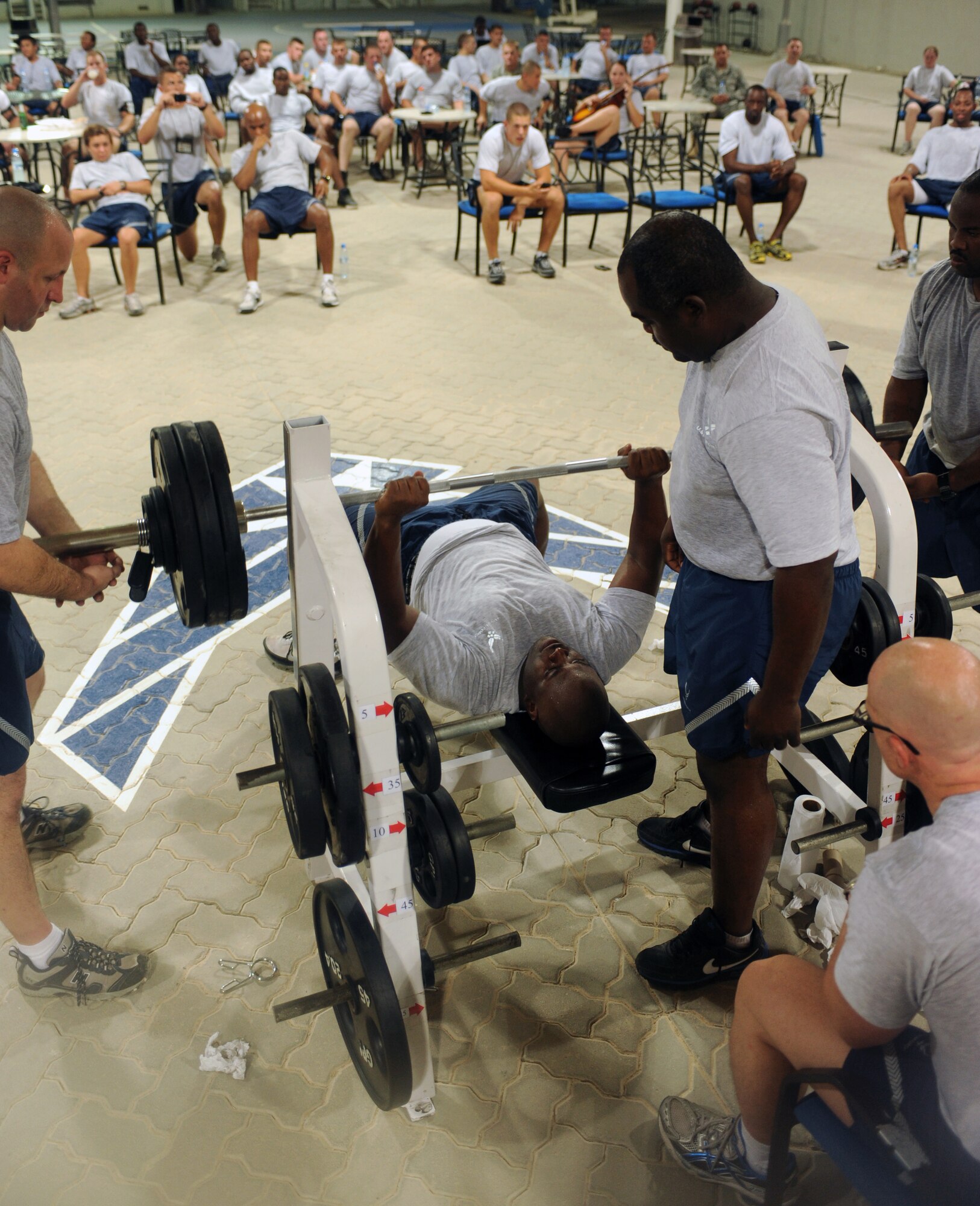 SOUTHWEST ASIA - Members of the 380th Air Expeditionary Wing participate in a bench press contest July 25. The contest is held biannually and contestants compete in appropriate weight classes. (U.S. Air Force photo Tech. Sgt. Charles Larkin Sr)