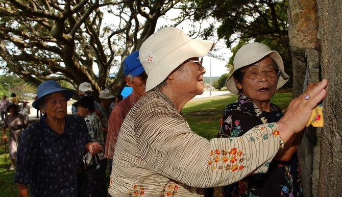 Okinawans get a glimpse of an old aircraft hangar near Gate 3 at Kadena Air Base, Japan July 23.  Nearly 90 visitors ages 60-90 years old from the Okinawa Prefectural Disabled Veterans Association toured to specific war-related sites on base. This group is very unique as they  served in the Imperial Japanese Army during the Battle of Okinawa, sustained  injuries in the war, and have been receiving military pensions from the Government of Japan. They were not directly deployed to Okinawa during the war, but drafted from here to serve in the Army.
(U.S. Air Force photo/Tech. Sgt. Rey Ramon)                         