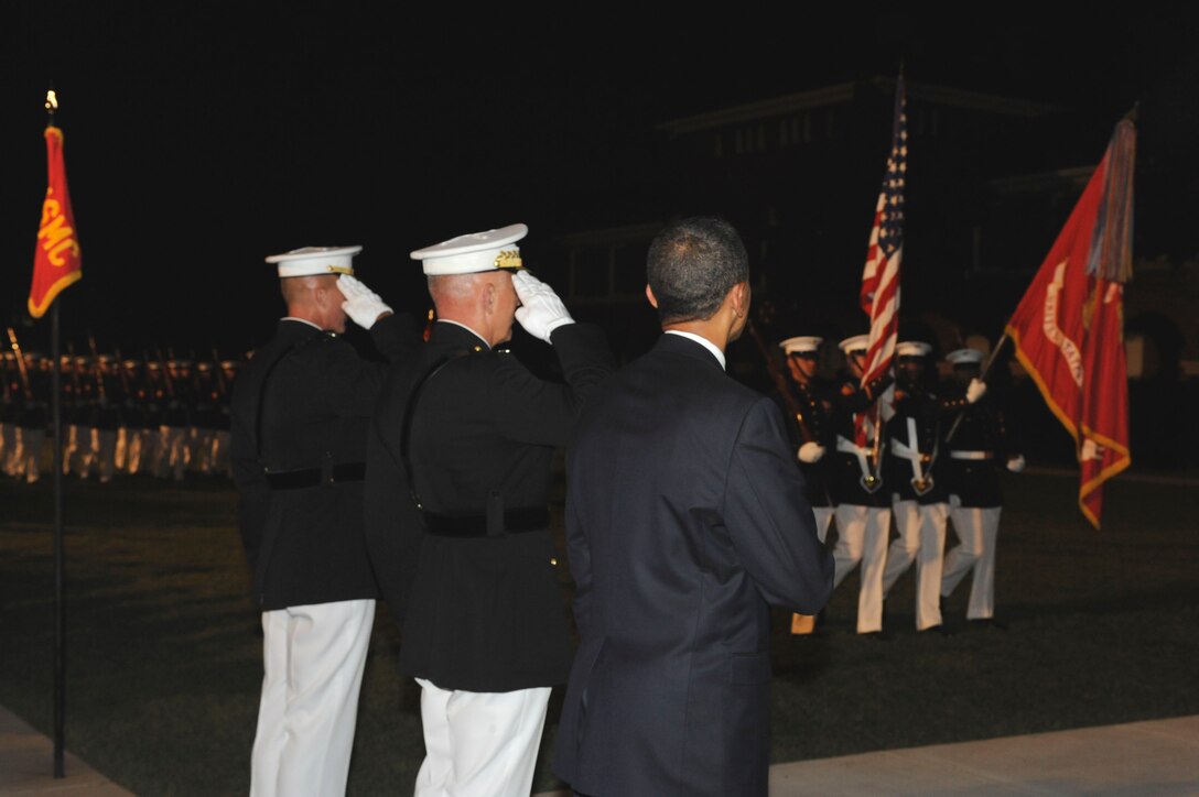 Marine Barracks Washington Commanding Officer Col. Andrew Smith, left, Marine Corps Commandant Gen. James T. Conway, center, and The President Barack Obama render honors during a pass in review at the Evening Parade at Marine Barracks Washington, D.C., July 24, 2009.