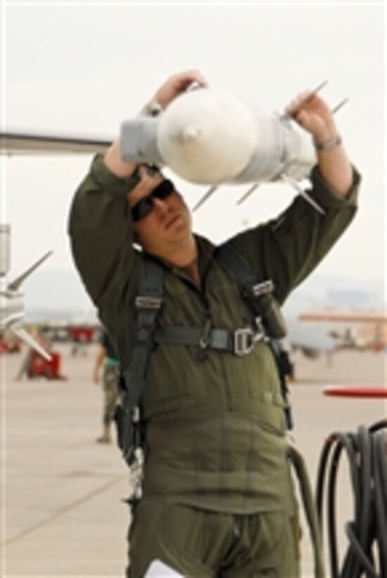 U.S. Air Force Capt. Luke Jones, an F-16 pilot from the 180th Fighter Wing, Ohio Air National Guard, inspects an A-120 missile before a combat training mission during a Red Flag exercise at Nellis Air Force Base, Nev., on July 20, 2009.  Red Flag is a highly realistic combat training exercise that pits U.S. and allied nation air forces against simulated enemy forces in a challenging air, ground, cyberspace and electronic threat environment.  