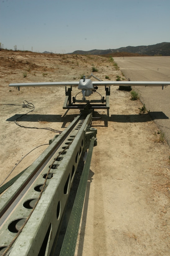 A RQ-7B "Shadow 200 beloning to Marine Unmanned Aerial Vehicle Squadron 1, sits on top of its launcher before a training flight aboard Marine Corps Base Camp Pendleton, July 27. The launcher ejects the unmanned aircraft at speeds exceeding 20 mph to get the 375-pound aircraft airborne. (Official U.S. Marine Corps photo by Cpl. Christopher O'Quin)(Released)