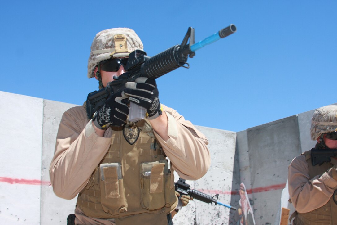 Cpl. Thomas Hammond, a military policeman with the Combat Center's Provost Marshal's Office's Special Reaction Team, scans a room at Combat Center Range 111 with other members of SRT July 29.