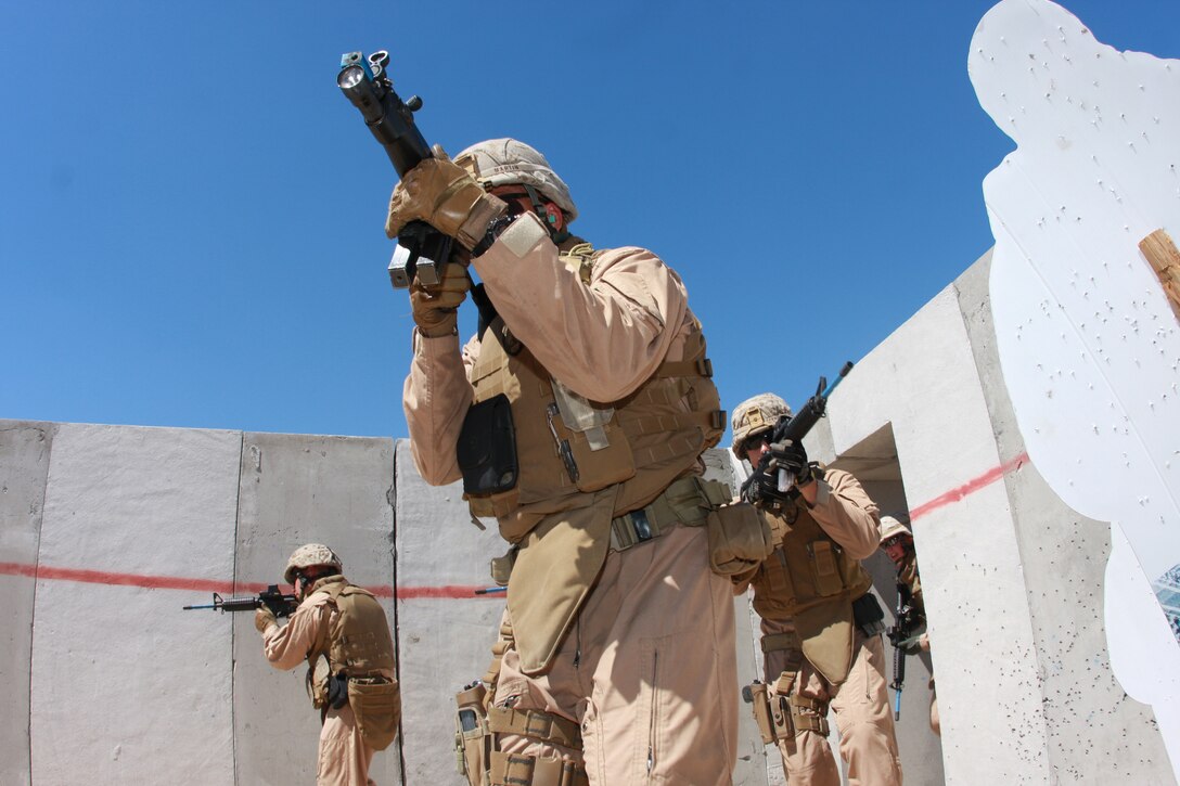 The Combat Center's Provost Marshal's Office's Special Reaction Team pours into a room at Combat Center Range 111 Wednesday when they conducted urban warfare training in preparation for future operations.