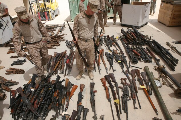 Marines with Engineer Ordnance Maintenance Platoon, Maintenance Company, 2nd Supply Battalion Reinforced, 2nd Marine Logistics Group (Forward), sort captured enemy weapons at the Taji National Maintenance Depot aboard Camp Taji, Iraq, July 28, 2009.  The depot is responsible for destroying unserviceable weapons and turning over serviceable weapons to the Iraqi government to support the Iraqi Army. (U.S. Marine Corps photograph by Cpl. M. M. Bravo)