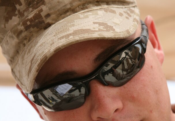 Lance Cpl. Bennett T. Richardson, an artillery mechanic with Engineer Ordnance Maintenance Platoon, Maintenance Company, 2nd Supply Battalion Reinforced, 2nd Marine Logistics Group (Forward), reports the serial number of a serviceable captured enemy weapon at the Taji National Maintenance Depot aboard Camp Taji, Iraq, July 28, 2009.  The depot is responsible for destroying unserviceable weapons and turning over serviceable weapons to the Iraqi government to support the Iraqi Army. (U.S. Marine Corps photograph by Cpl. M. M. Bravo)