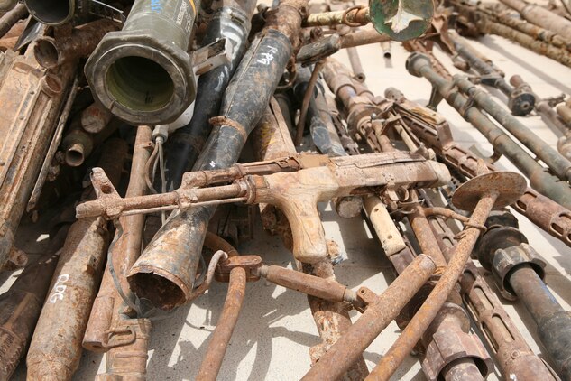 Unserviceable captured enemy weapons delivered by Marines with Engineer Ordnance Maintenance Platoon, Maintenance Company, 2nd Supply Battalion Reinforced, 2nd Marine Logistics Group (Forward) to the Taji National Maintenance Depot aboard Camp Taji, Iraq, lay in a pile waiting to be destroyed, July 28, 2009.  The depot is responsible for destroying unserviceable weapons and turning over serviceable weapons to the Iraqi government to support the Iraqi Army. (U.S. Marine Corps photograph by Cpl. M. M. Bravo)