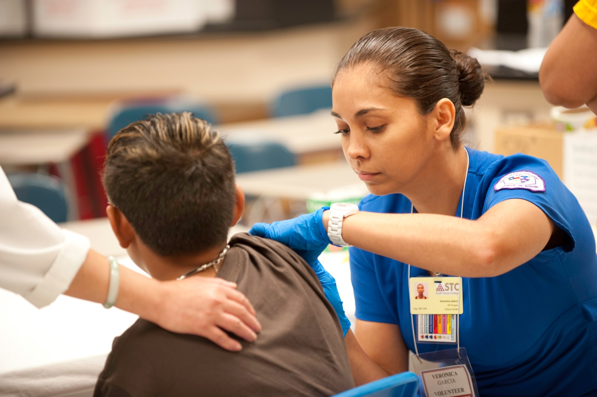 Veronica Garcia from South Texas College nursing program volunteers her time to help those in need at Operation Lone Star held at Raymond High School July 27, 2009. (U.S. Air Force photo by  Tech Sgt Hatton)

