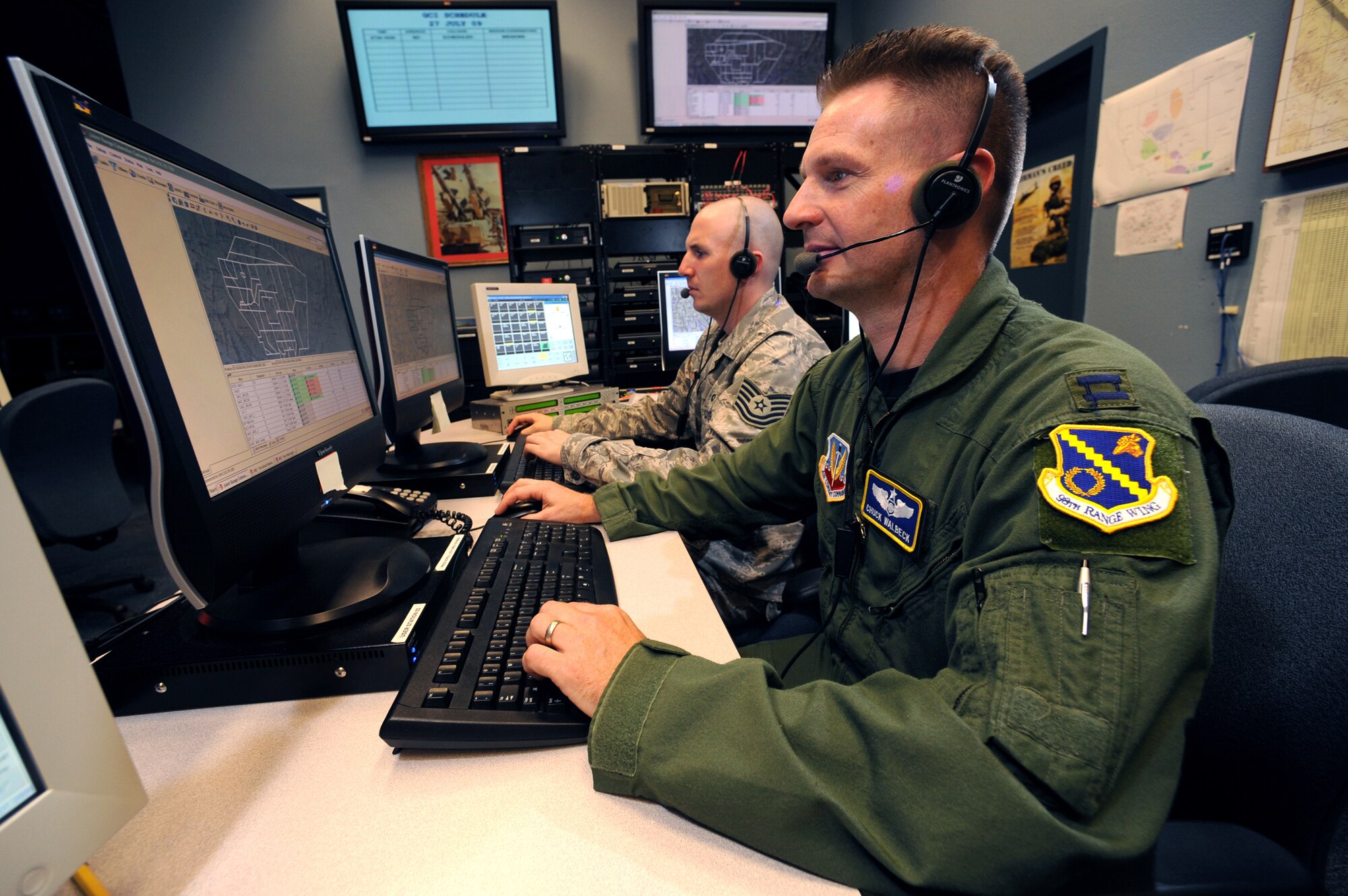 Capt. Charles Walbeck and Tech. Sgt. Kevin Kessell, 98th Range Wing data link technicians, operate and maintain the Nevada Test and Training Range from the Combined Operations Center at Nellis Air Force Base, Nev., July 28. The 98 RANW integrates and support testing and training programs that have a direct effect on the war fighting capabilities of the combat air forces. (U.S. Air Force photo by Tech. Sgt. Michael R. Holzworth)