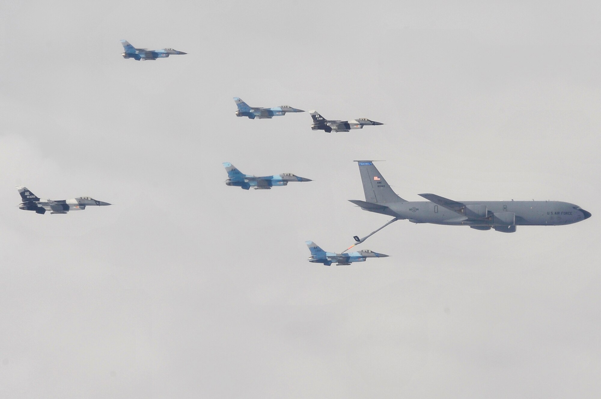 A formation of F-16 Aggressors receive fuel from a KC-135 from MacDill Air Force Base, Florida, over the Joint Pacific Alaskan Range Complex during Red Flag-Alaska 09-3 July 28, 2009, Eielson AFB. RF-A exercises are focused on improving the combat readiness of U.S. and Coalition Forces and providing training for units preparing for Air Expeditionary Force taskings. The F-16 belong to the 18th Aggressor Squadron. (U.S. Air Force photo/Staff Sgt. Christopher Boitz)