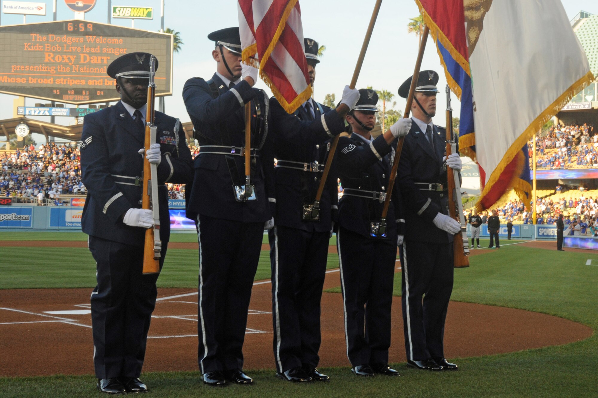 An Honor Guard from Los Angeles AFB posted the colors at the Dodgers game, July 24. The base and El Segundo Chamber of Commerce teamed up again to offer discounted tickets to the game against the Florida Marlins. Officials from LAAFB and the City of El Segundo were introduced on the field prior to the game. (Photo by Atiba S. Copeland)
