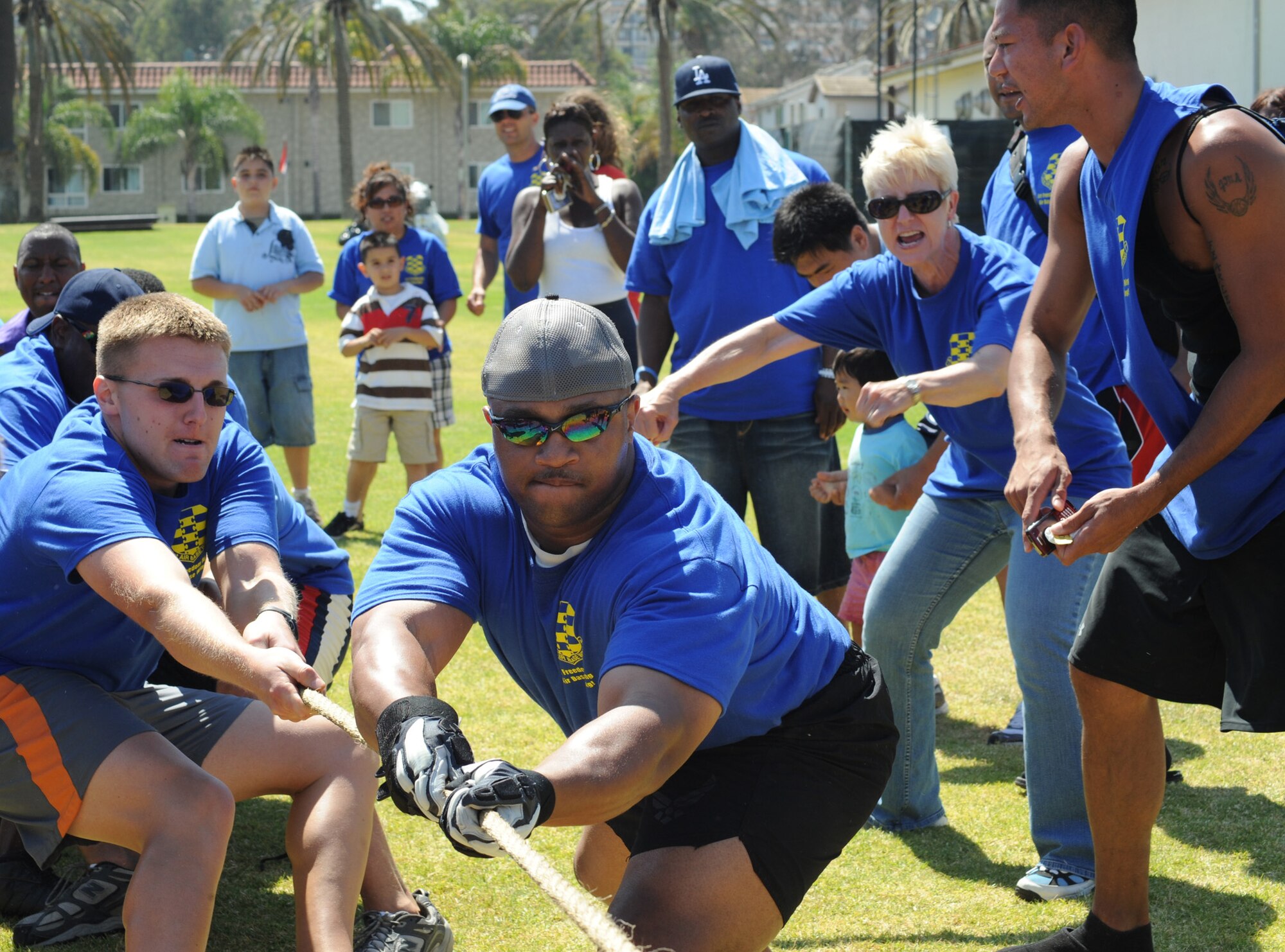 Members of the 61st Air Base Wing tug of war team are cheered on by Col. Anita Latin, 61st Air Base Wing commander, during SMC Sports Day, July 24. The 61st Air Base Wing took the overall  Sports Day title.  (Photo by Joe Juarez)