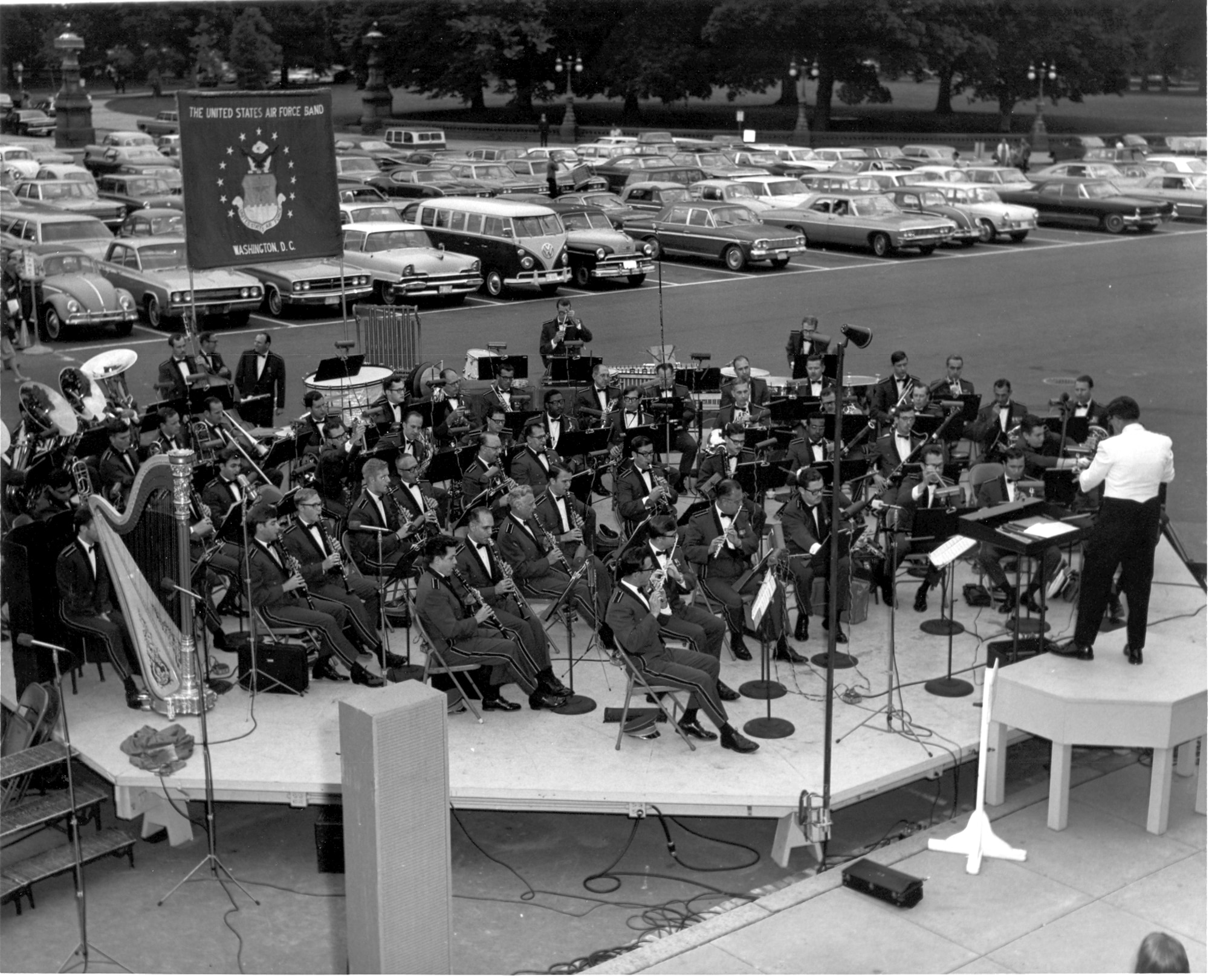 First photo:  The United States Air Forces plays an outdoor summer concert on the East side of the Capitol Building in 1968 or 1969. The conductor is Captain Albert A. Bader, the assistant conductor to Lieutenant Colonel Arnald D. Gabriel, The Air Force Band's commander and conductor.   (Official photo of The Air Force Band.)
