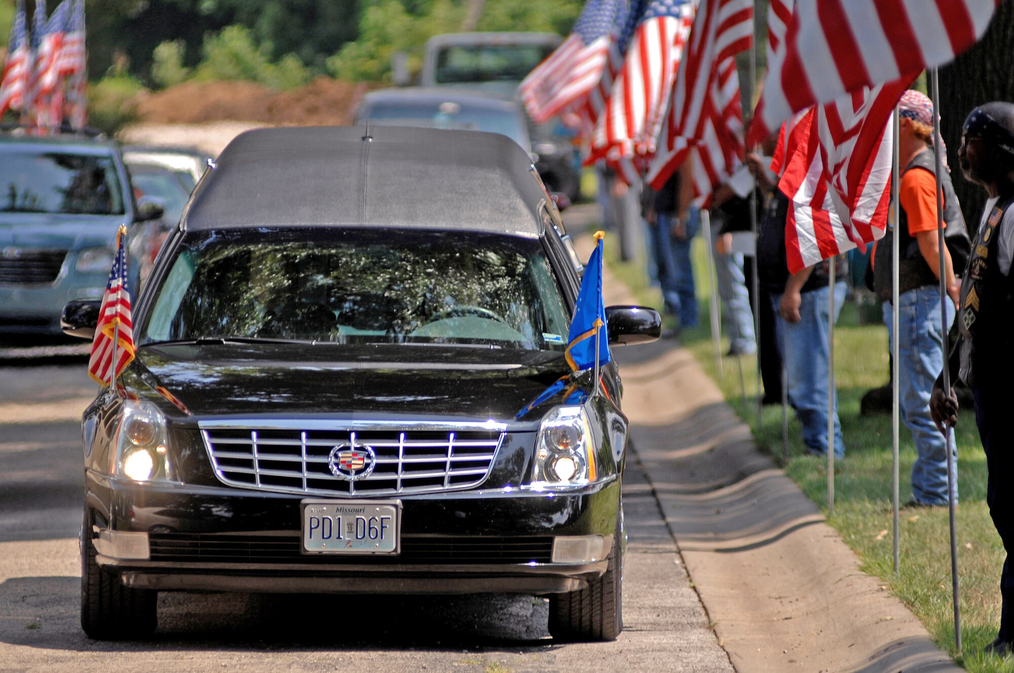 A hearse containing the casket of Chief Master Sgt. Quincy Adam makes its way to his grave site July 27 at Chapel Hill Memorial Cemetery. Chief Adam is a Vietnam War veteran who was missing in action for more than 40 years. Chief Adam's remains were discovered in Southeast Asia, and he was finally brought home to be laid to rest, giving his family closure in their lives. (U.S. Air Force photo/Senior Airman Kenny Holston)