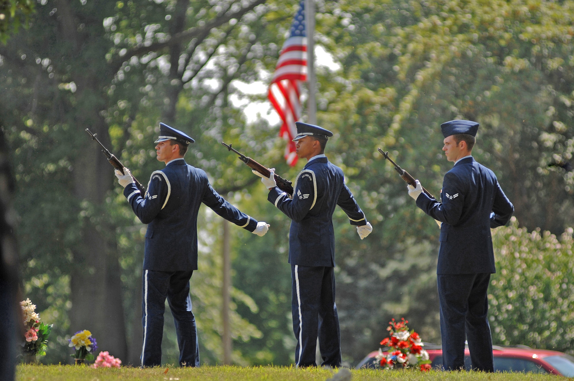 Airmen with the Whiteman Air Force Base Honor guard render a 21-gun salute July 27 to honor Chief Master Sgt. Quincy Adam at Chapel Hill Memorial Cemetery. Chief Adam is a Vietnam War veteran who was missing in action for more than 40 years. Chief Adam's remains were discovered in Southeast Asia and he was finally brought home to be laid to rest, giving his family closure in their lives. (U.S. Air Force photo/Senior Airman Kenny Holston)