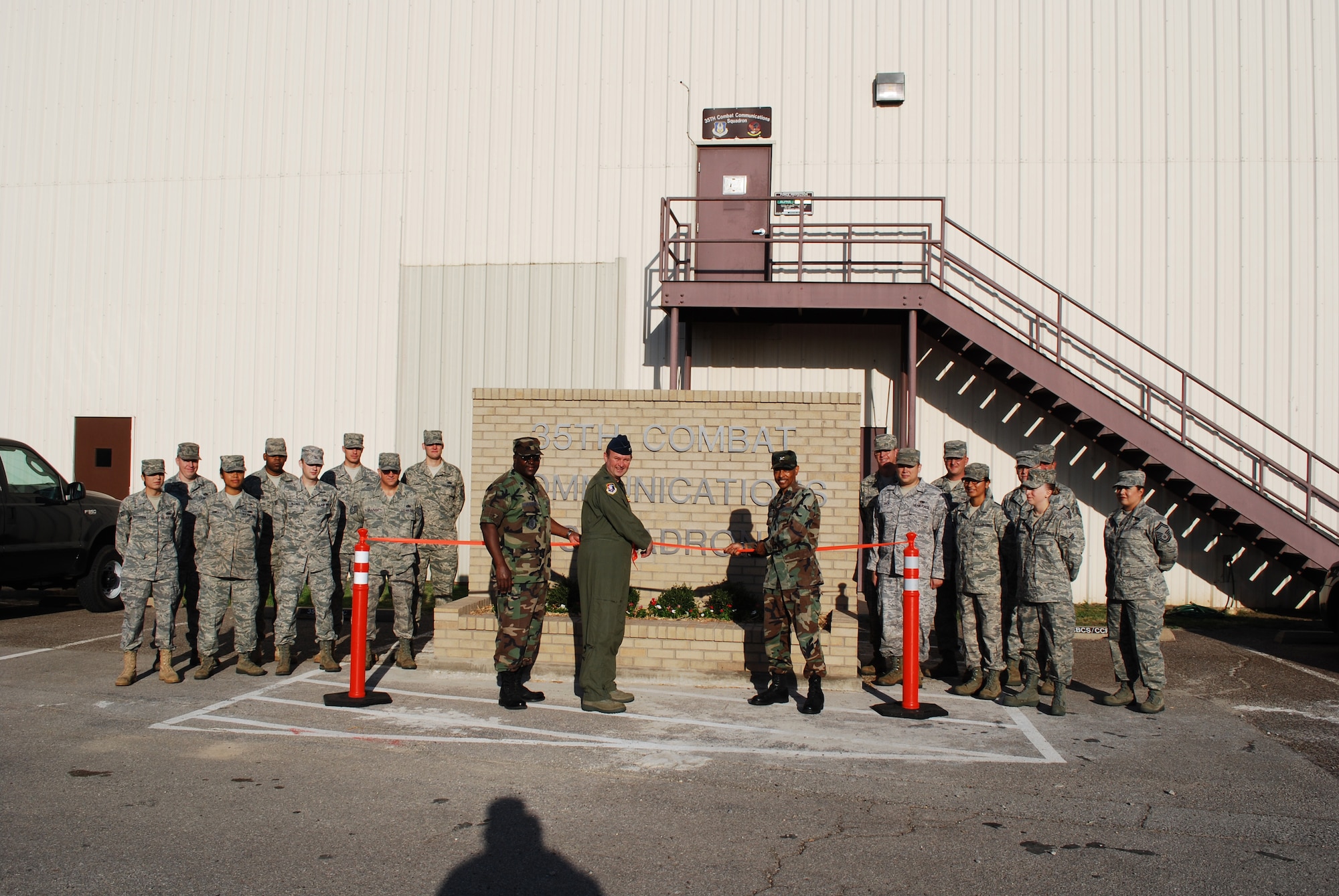 The 35th Combat Communications Squadron added a permanent reminder of their presence on base July 10 during a dedication of their new building sign.  The sign, a self-help construction project, cost roughly $4,600 and took two months to build.  Shown above are, left to right, Lt. Col. Pete Peterson, 35th CBCS Commander, Col. Jeffery R. Glass, 507th ARW commander and Col. Rodney Bryan, 507th Mission Support Group commander during the ribbon cutting ceremony.