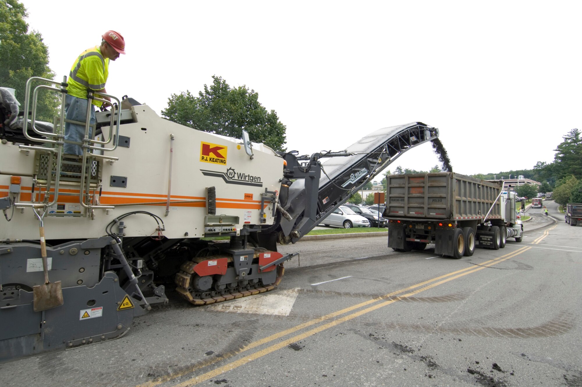 HANSCOM AIR FORCE BASE, Mass. - A contractor for Hanscom’s Civil Engineering uses an asphalt milling machine to grind up Bestic Drive between Barksdale Street and Schilling Circle, which eventually was re-paved. The paving project, which took place between July 13 and July 21, is one of 41 other base-wide projects all part of the American Recovery and Reinvestment Act of 2009. These construction initiatives also comprise roofing and steam-line repair and have created 55 new contracted job opportunities. (U.S. Air Force photo by Rick Berry)