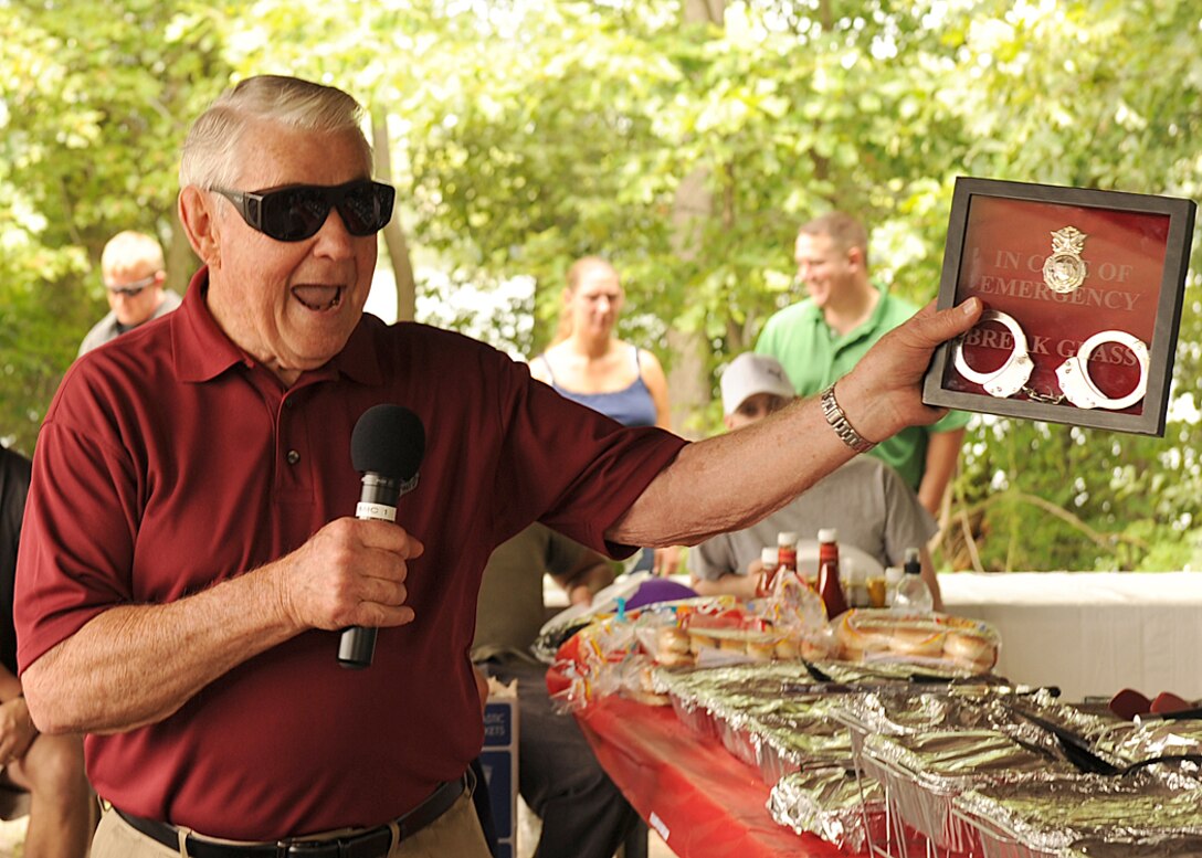 LANGLEY AIR FORCE BASE, Va. -- Bob Gaylor, fifth Chief Master Sgt. of the Air Force, accepts a memento from the 1st Security Forces Squadron July 24. Chief Gaylor is touring Langley, and speaking to Airmen about the Air Force and how to keep your self motivated. (U.S. Air Force photo/Airman 1st Class Jonathan Koob)
