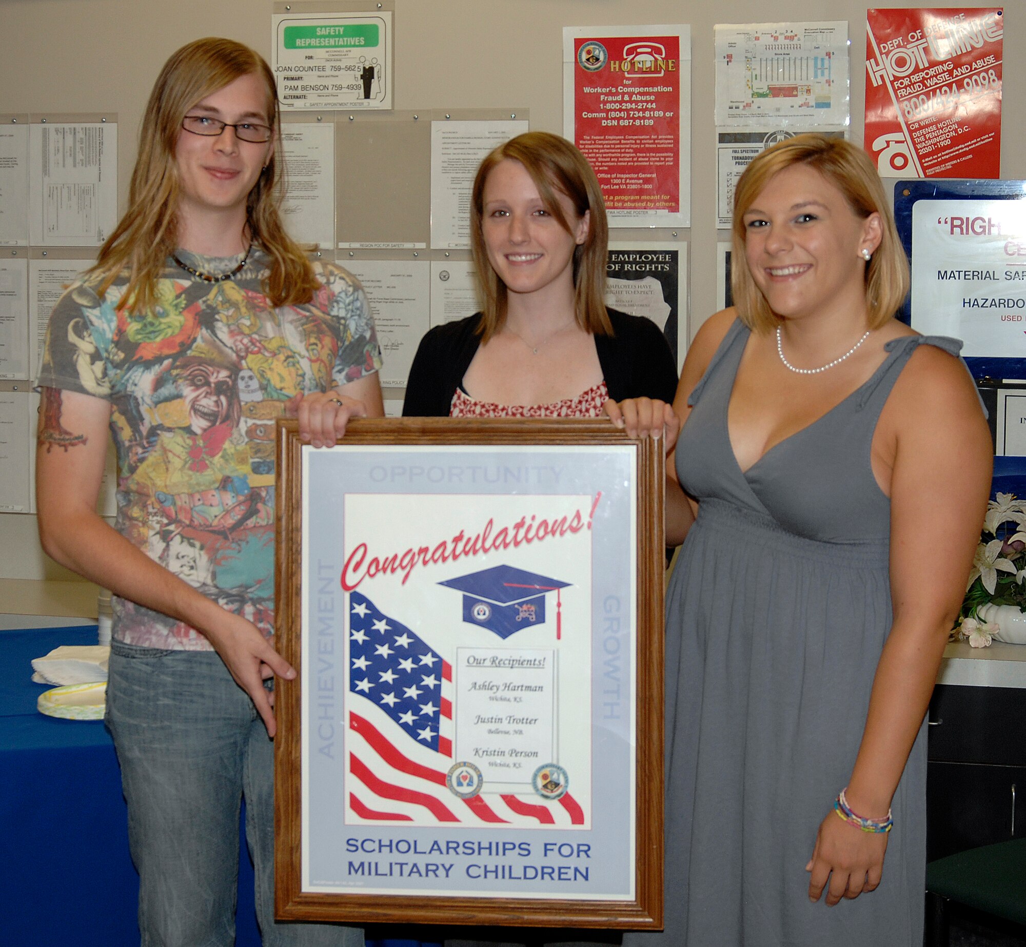 MCCONNELL AIR FORCE BASE, Kan. -- Justin Trotter, Ashley Hartman, and Kristin Person, were selected to receive Scholarships for Military Children, July 24. The scholarship presentation was held at the McConnell commissary. To receive the scholarships, the students wrote an essay based on one item they would place in a time capsule that depicts the military in this era. (Photo by Senior Airman Laura Suttles)