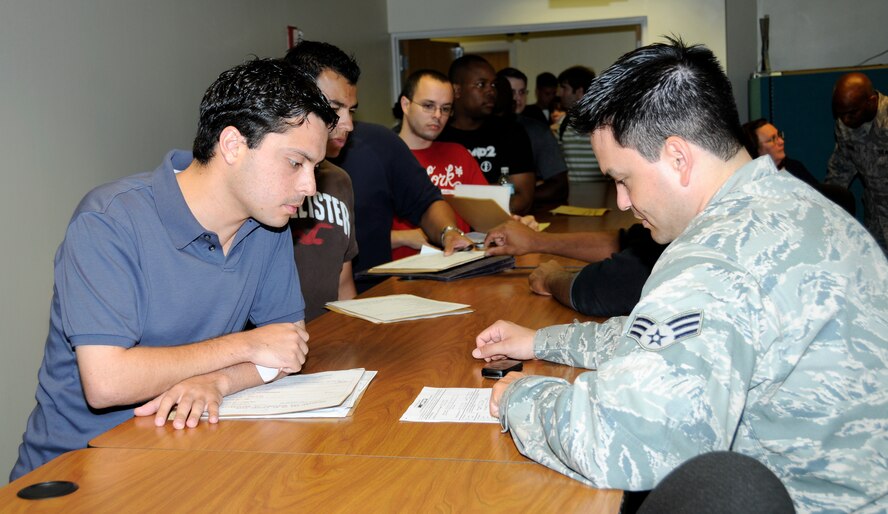 Senior Airman Norlys Oria, 482nd Fighter Wing Finance Office, updates financial information for a member during the IRR screening program on July 25.  Over 100 South Florida members of the Air Force Nonparticipating Individual Ready Reserve gathered for the annual muster screening to update contact information and receive briefings and information on benefits at the base. (U.S. Air Force photo/Tim Norton)