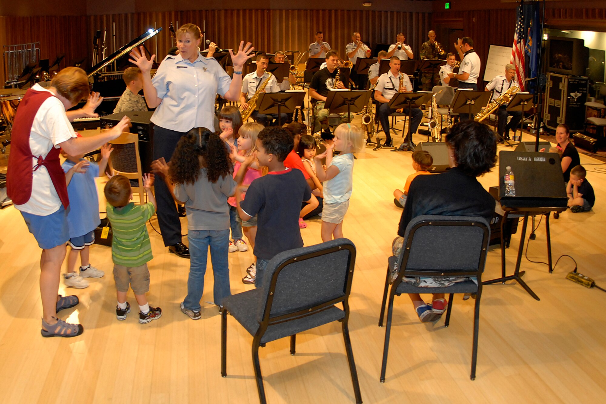 Children from the Peterson Child Development Center listen to a rehearsal given by the U.S. Air Force Academy jazz ensemble at Peterson July 27. During the summer, the children tour units on base to learn different aspects of the many Air Force missions hosted here by the 21st Space Wing.  (U.S. Air Force photo by Larry Hulst)