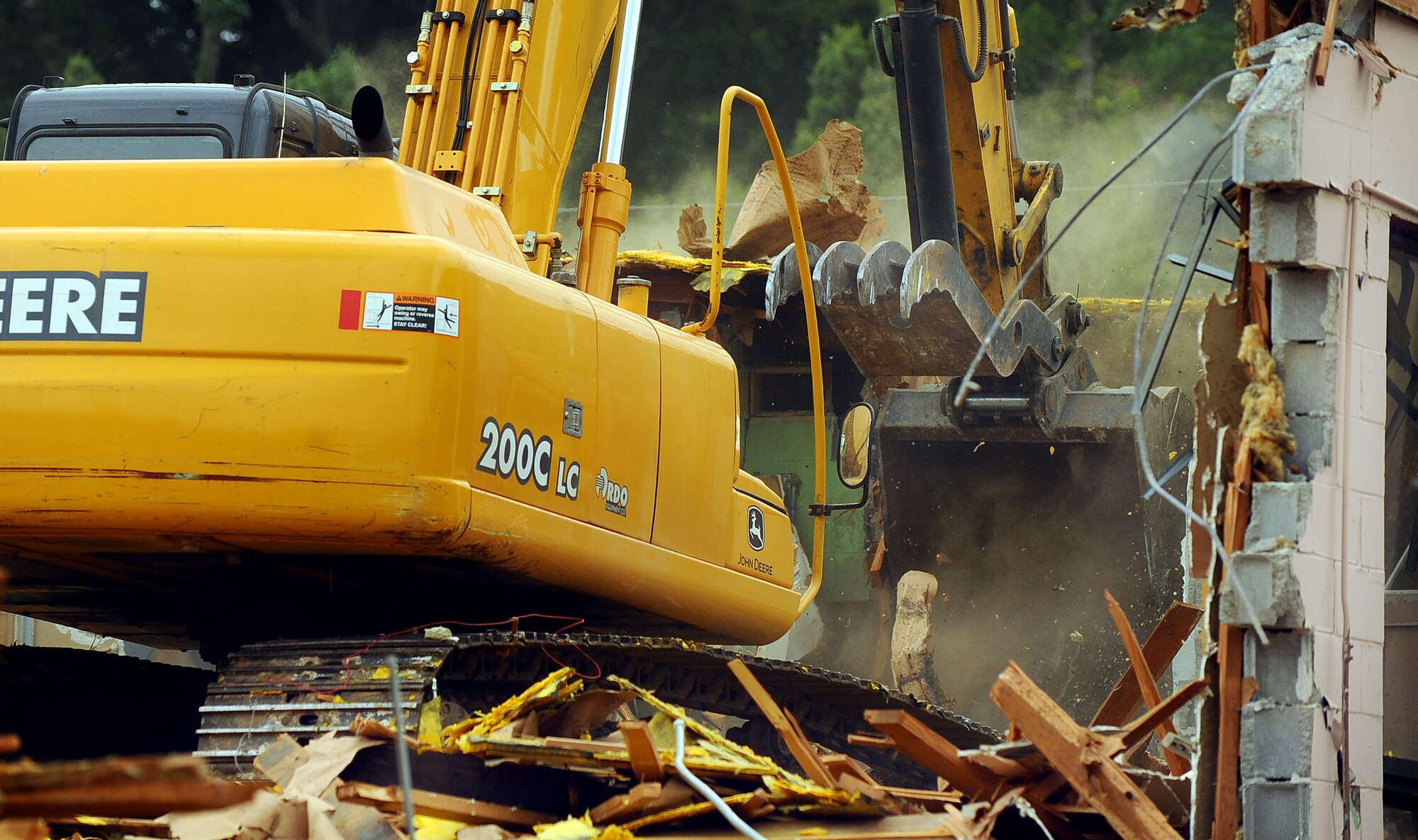 OFFUTT AIR FORCE BASE, Neb. -- Building 418 is demolished here July 27. The facility served numerous purposes including as an Airman's club, community center and military clothing sales store. U.S. Air Force Photo by Josh Plueger