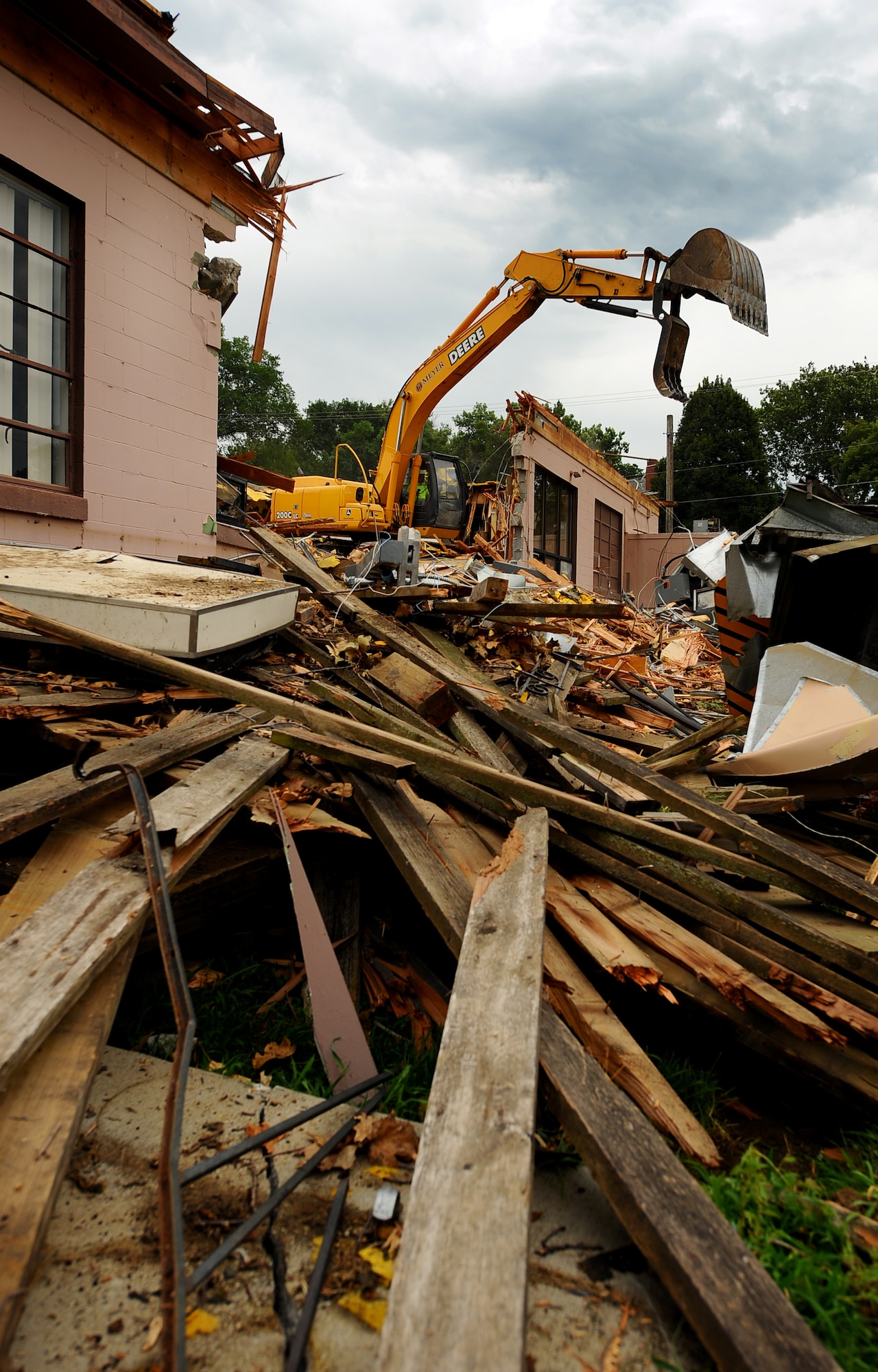 OFFUTT AIR FORCE BASE, Neb. -- Building 418 is demolished here July 27. The facility served numerous purposes including as an Airman's club, community center and military clothing sales store. U.S. Air Force Photo by Josh Plueger