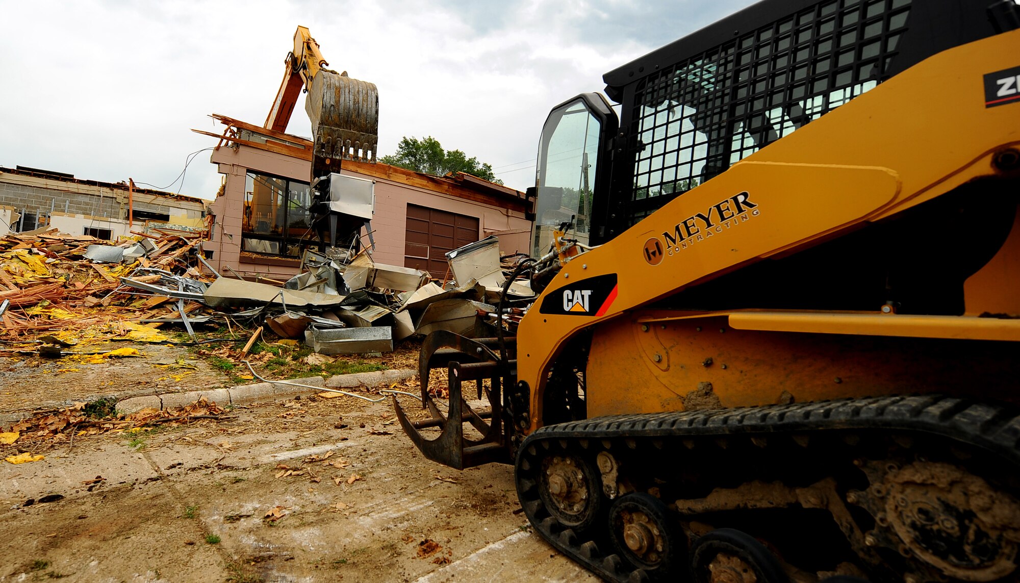 OFFUTT AIR FORCE BASE, Neb. -- Building 418 is demolished here July 27. The facility served numerous purposes including as an Airman's club, community center and military clothing sales store. U.S. Air Force Photo by Josh Plueger