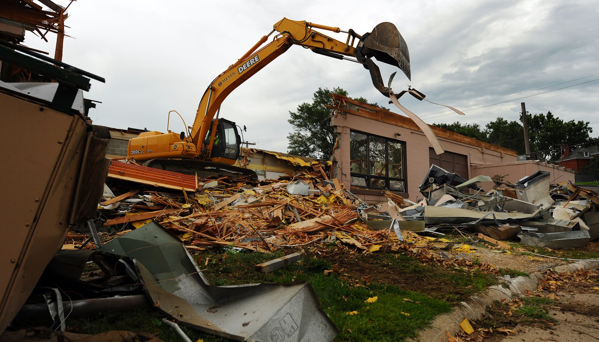 OFFUTT AIR FORCE BASE, Neb. -- Building 418 is demolished here July 27. The facility served numerous purposes including as an Airman's club, community center and military clothing sales store. U.S. Air Force Photo by Josh Plueger