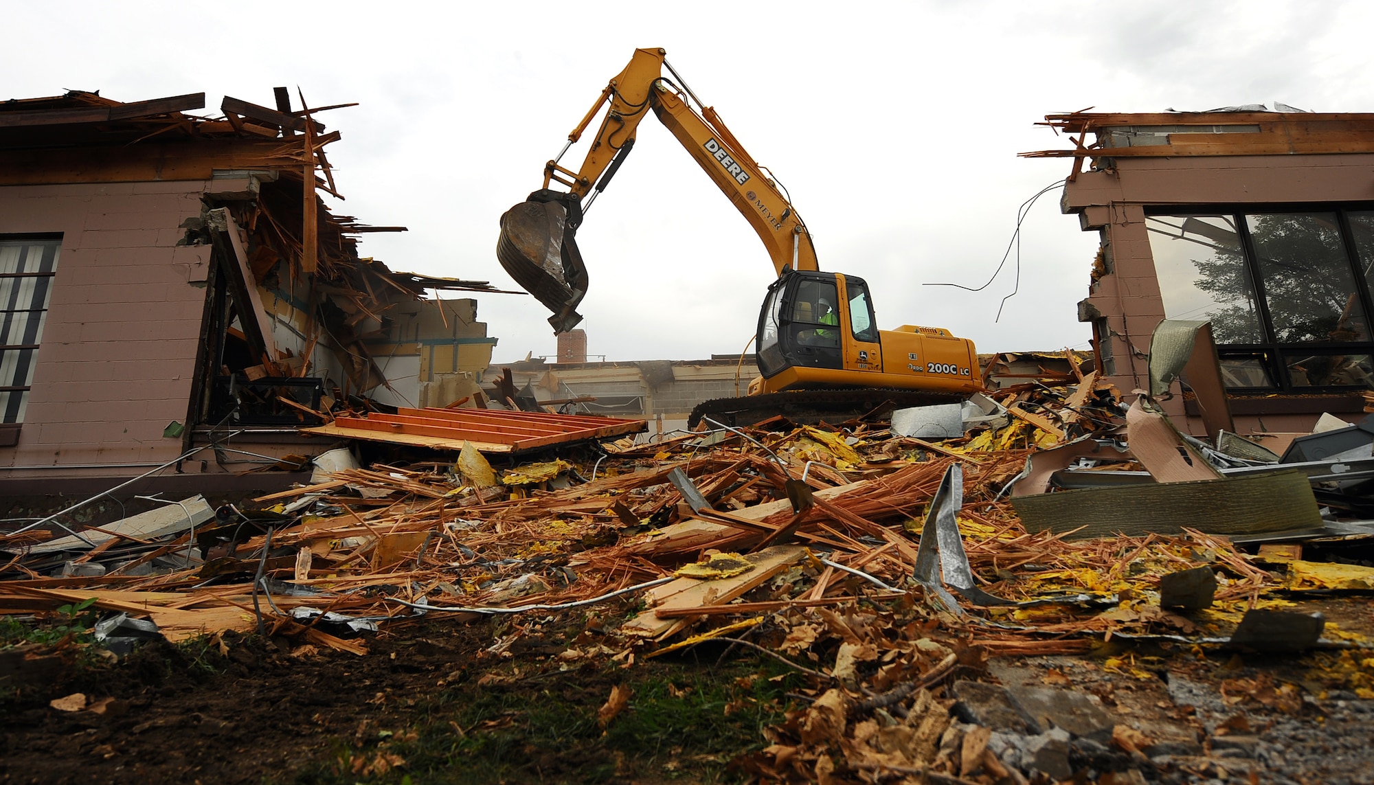 OFFUTT AIR FORCE BASE, Neb. -- Building 418 is demolished here July 27. The facility served numerous purposes including as an Airman's club, community center and military clothing sales store. U.S. Air Force Photo by Josh Plueger