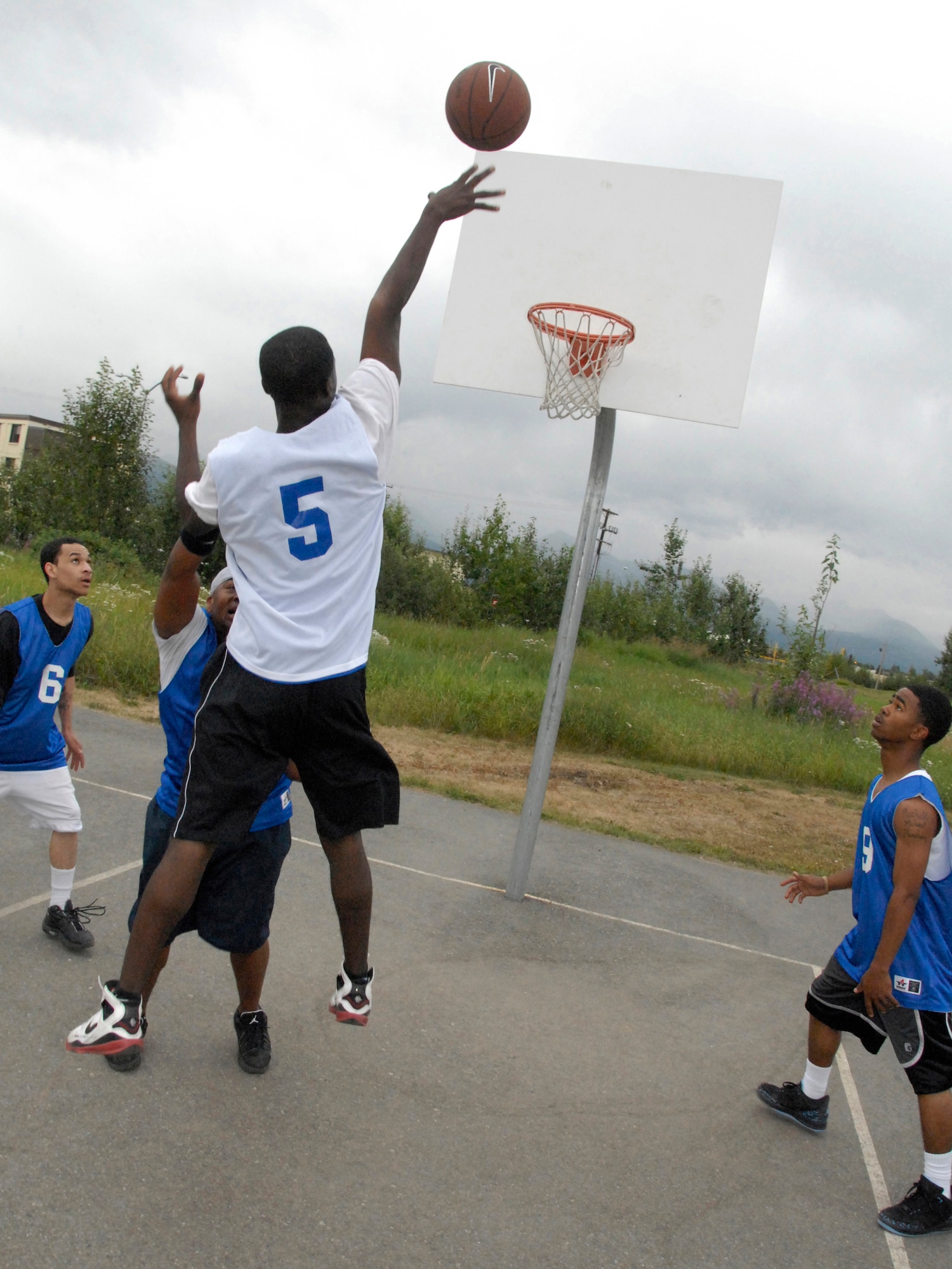 ELMENDORF AIR FORCE BASE, Alaska -- Airmen compete in a 3-on-3 basketball tournament during the Airman's Appreciation Barbecue July 25. More than 100 Airmen participated in the outdoor events held at the dormitories. (U.S. Air Force photo/Airman 1st Class Joe Ovel)