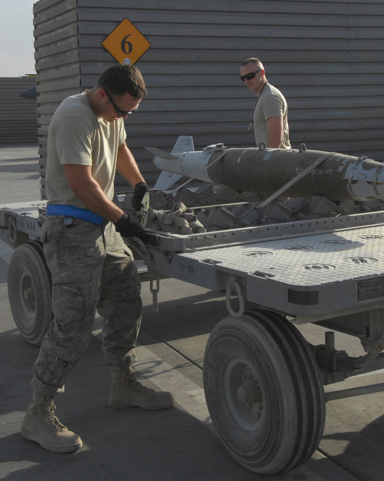 BAGRAM AIRFIELD, Afghanistan -- Providing weapons for the fight, Staff Sgt. Todd Wolf, a Saint Joseph, Mo. native now deployed from Charleston Air Force Base's 437th Maintenance Squadron in South Carolina, works with Airman 1st Class Michael Chiniquy deployed from the 23rd Maintenance Group at Moody Air Force Base, Ga., to deliver weapons to their awaiting A-10 Thunderbolt II, also known as the Warthog.  The A-10 is well-liked by ground commanders in combat due to its high payload, ability to stay on station over targets and the GAU-8 high explosive dispensing cannon in the nose of the aircraft.  The A-10 provides a critical role in Afghanistan's Operation Enduring Freedom. (U.S. Air Force photo by Capt. David Faggard)
