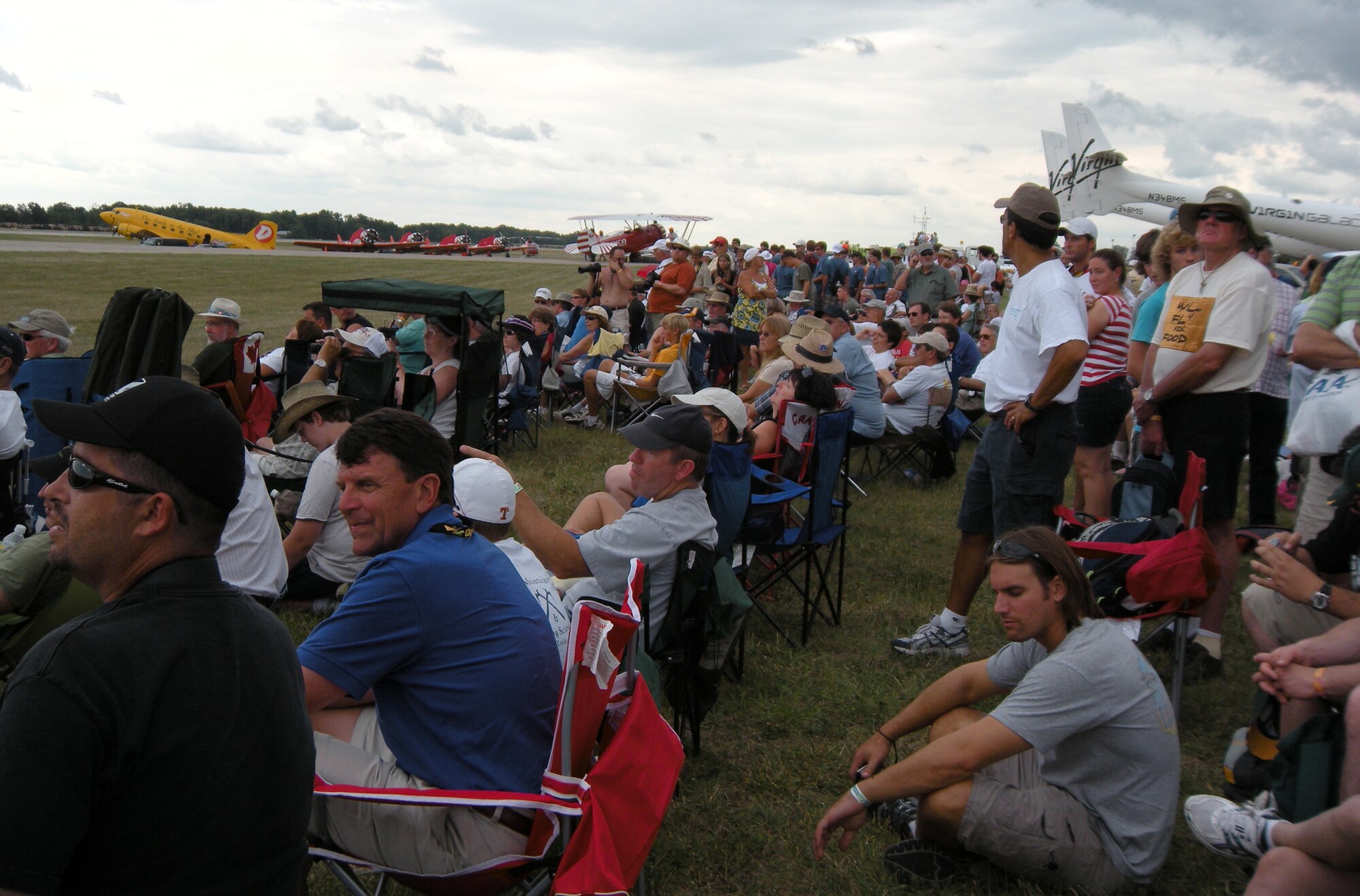 Thousands of aviation enthusiasts await the arrival of the Air Force Reserve's Modular Airborne Firefighting System-equipped C-130 at the Experimental Aviation Association's AirVenture airshow July 27 at Oshkosh, Wis. The 302nd Airlift Wing, the AF Reserve's only airlift unit assigned to aerial firefighting, performed a MAFFS water drop demo, showcasing the AF Reserve's aerial firefighting capabilities. The 302nd AW is based at Peterson Air Force Base, Colo. (U.S. Air Force photo/Ann Skarban)
