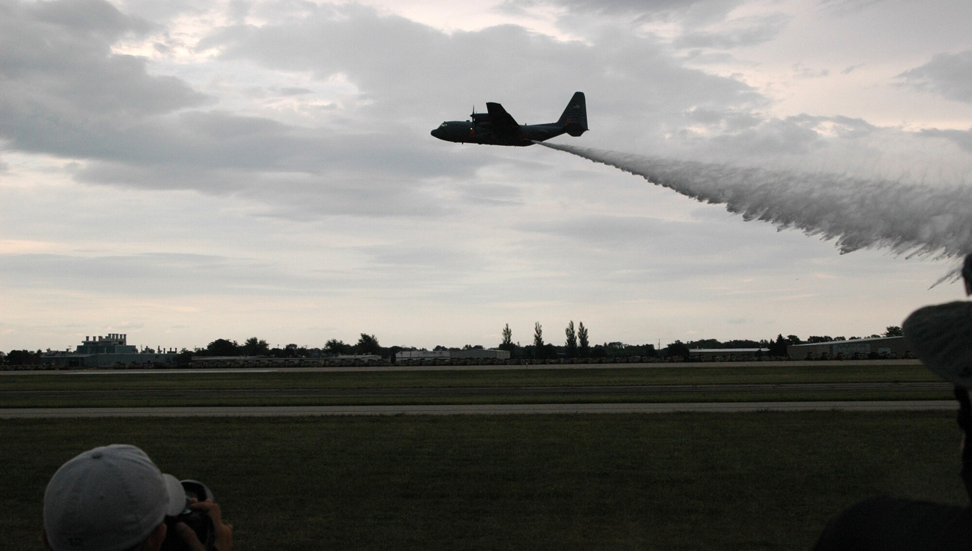 An Air Force Reserve C-130 equipped with the Modular Airborne Firefighting System, or 'MAFFS II, presents a live water drop July 27 at the Experimental Aircraft Association AirVenture airshow in Oshkosh, Wis. The airshow is known as the world's greatest aviation celebration and attracts hundreds of thousands of aviation enthusiasts from all over the world. The C-130, assigned to the 302nd Airlift Wing at Peterson Air Force Base, Colo., is equipped with the new MAFFS II system and is on display at EAA AirVenture through July 29. (U.S. Air Force Photo/Capt. Jeff Schoen)