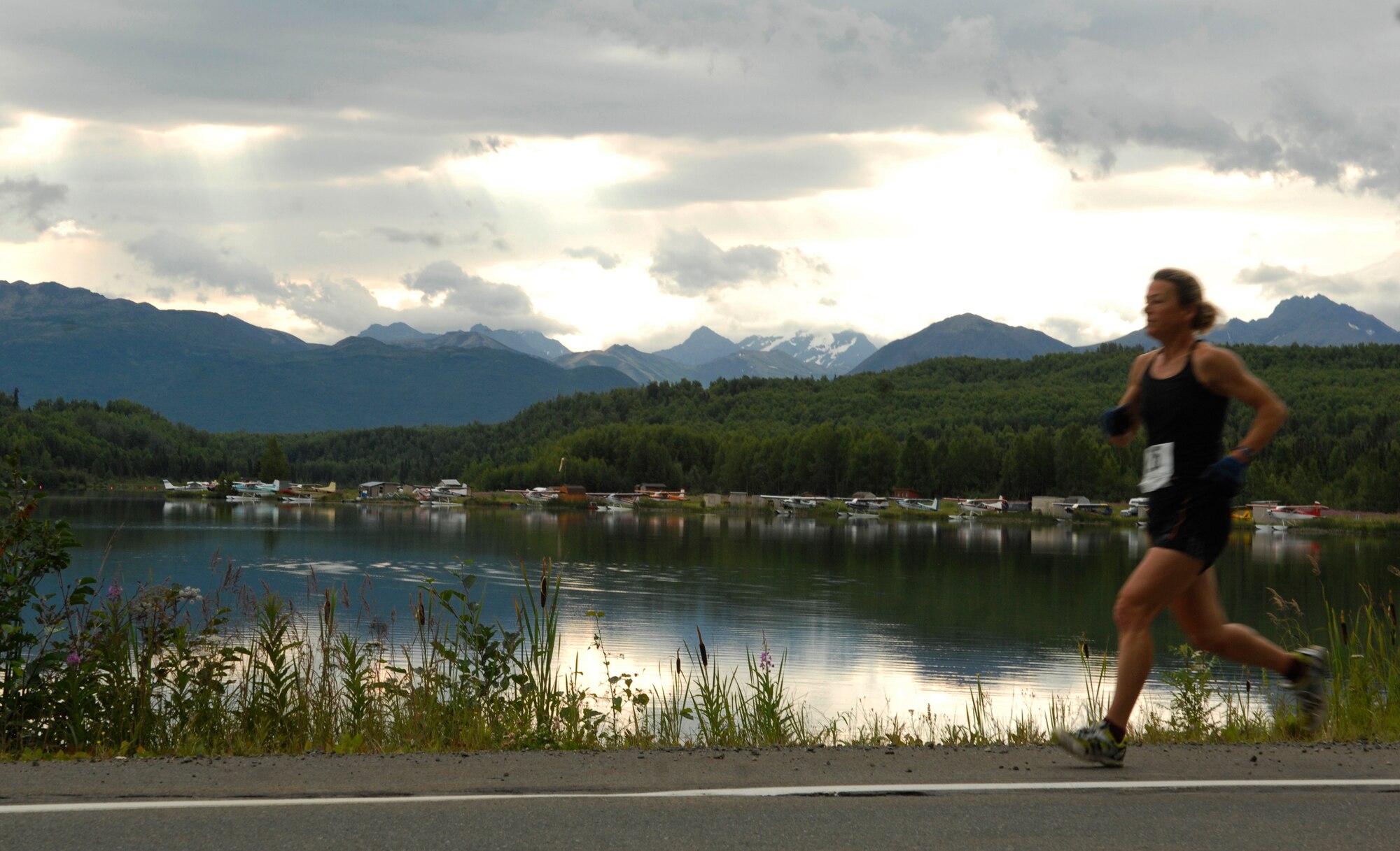 ELMENDORF AIR FORCE BASE, Alaska -- Debbie Cropper runs past Sixmile Lake during the Arctic Warrior Half Marathon July 25. She was the female winner of the event with a time of 1 hour, 32 minutes, 44 seconds. (U.S. Air Force photo/Senior Airman David Carbajal)