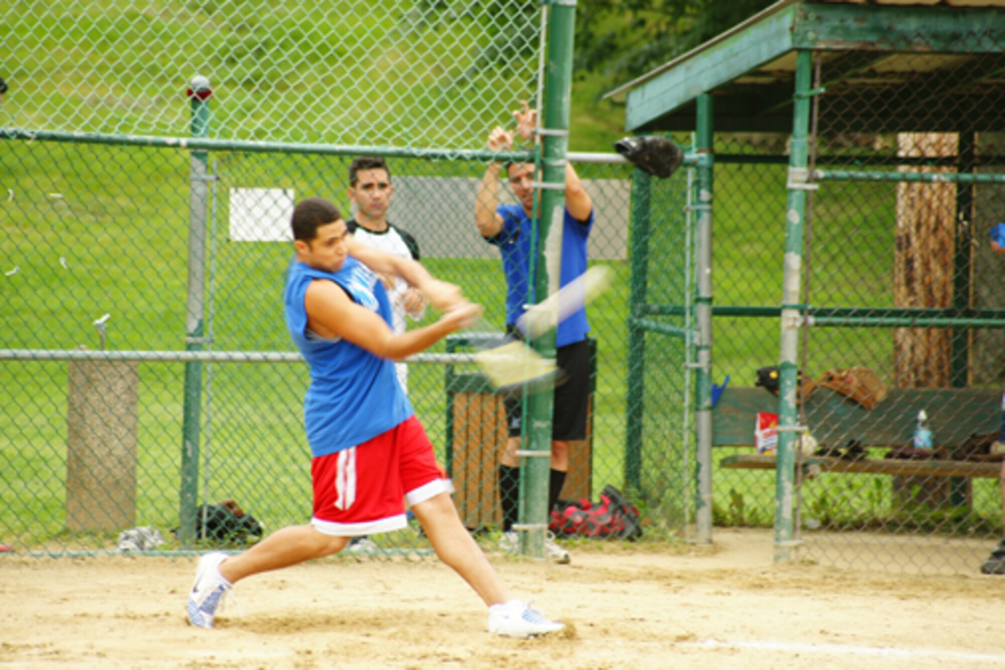 First Lt. Stephen Jimenez, Air Force Research Laboratory, takes a swing as teammates 1st Lt. Peter Foster and 2nd Lt. Frank Schiavone of the 66th Contracting Squadron look on. The lieutenants played on the company grade officers team in a July 15 softball game against the base's colonels and Top 3 members. The CGOs won the game 20-12.  (Courtesy photo by 1st Lt. Chris Wenz)