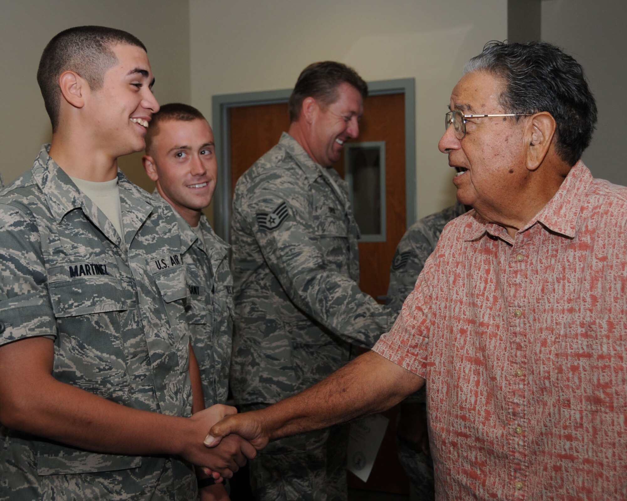From left, Airmen Basic Gil Martinez and Jared Surprenant and Staff Sgt. Steven Gatlin, students in the 336th Training Squadron’s last radio communications operations course, are congratulated after the graduation ceremony by special guest Manuel Moreno, July 21 in Thomson Hall.  Mr. Moreno, who had 57 years combined military and civil service before his retirement in 2005, was a military ground radio instructor from 1974-1980 and taught the personnel and communications operations course from 1980-1991 before returning to the radio course as an instructor from 1991-2005.  In 61 years, about 15,000 radio operators have been trained at Keesler.  The career field is merging into three new career fields — radio frequency transmissions, cyber surety or client systems.  (U.S. Air Force photo by Kemberly Groue)