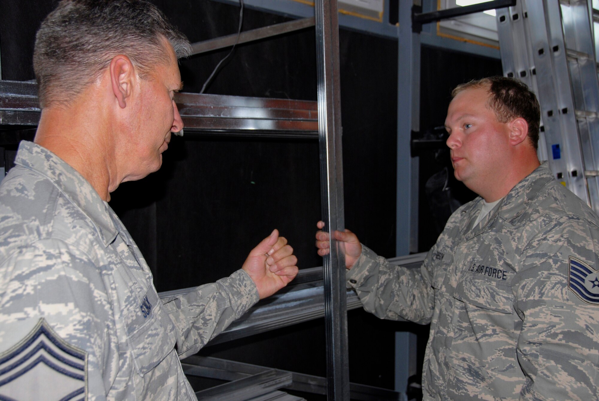 In a paint store in Tapolca, Hungary, Chief Master Sgt. Tom Schack discusses a purchase with Tech. Sgt. Sean Gibson on July 22, 2009. The Airmen are from the 133rd Civil Engineering Squadron of the Minnesota Air National Guard and they are in Hungary for a training deployment that includes construction work on a military installation. Tapolca is a larger town outside of ?jd?r?gd where the Squadron is performing a two week Deployment for Training. USAF photo by Staff Sgt. Amber Monio.