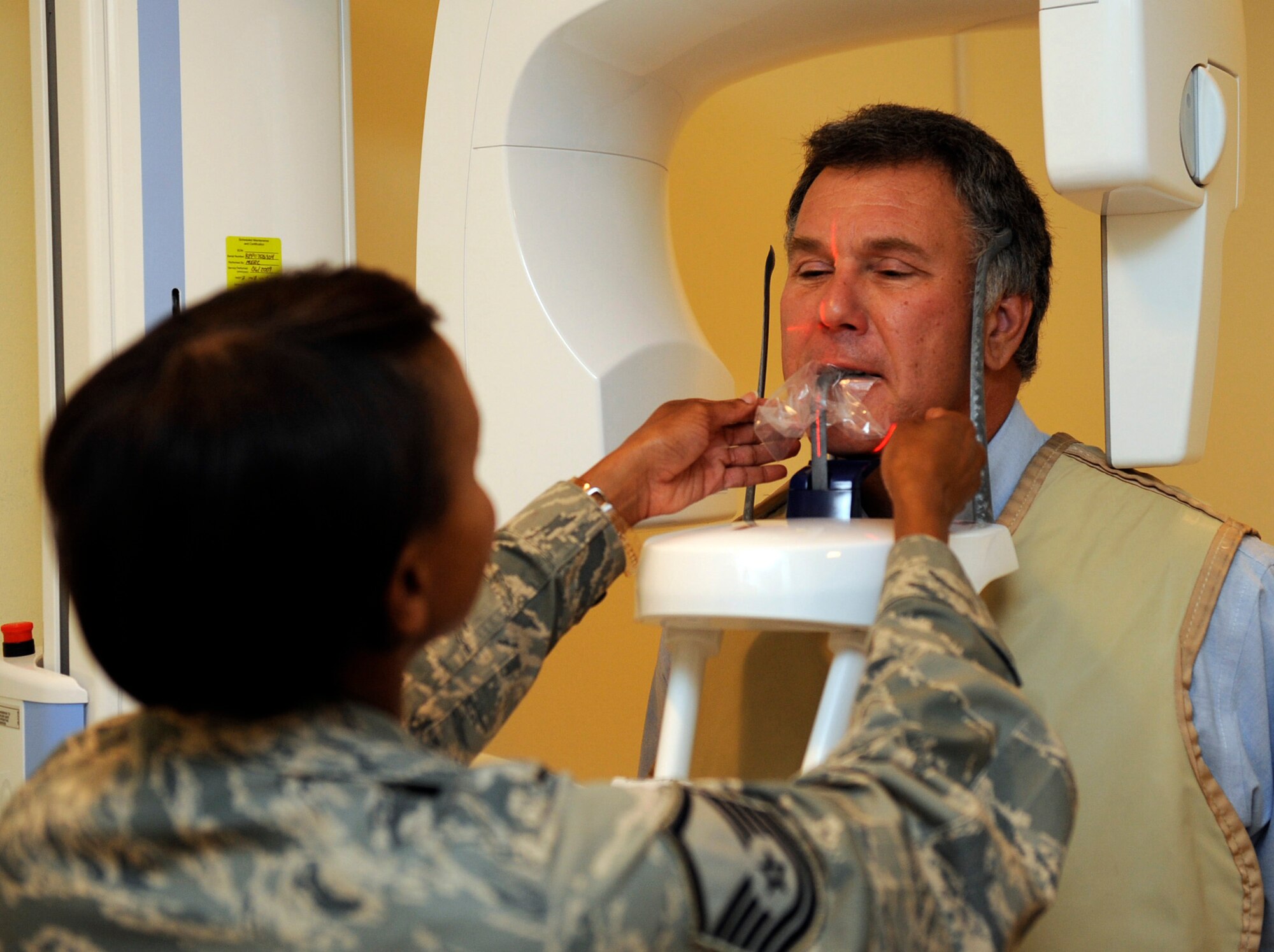 MOUNTAIN HOME AIR FORCE BASE, Idaho -- Master Sgt. Sylvia Wood, 366th Dental Squadron, noncommissioned officer in charge of the clinical dentistry flight, prepares Charles Connolly, Park Pointe Development real estate vice president and 366th Component Maintenance Squadron honorary commander, for an x-ray during the Honorary Commander Medical Group Day at the base hospital July 24. The honorary commanders program is a wing-level program that pairs civic leaders with squadron, group and wing leaders to enhance the relationships between local communities and the base. It also provides a rare glimpse of life on a military installation to members of neighboring communities -- many of whom have no connection to the Air Force or prior knowledge of the military. (U.S. Air Force photo by Airman 1st Class Debbie Lockhart)
