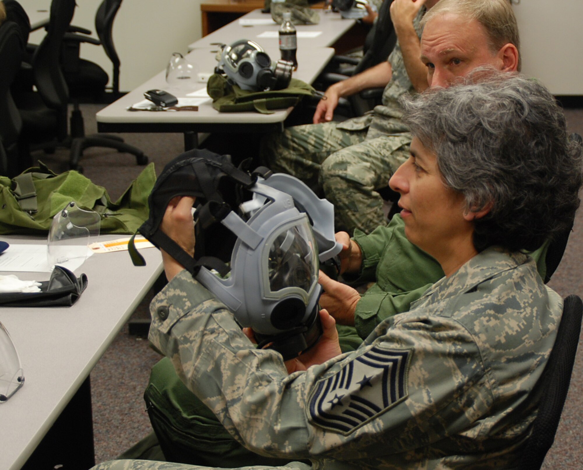 Command Chief Master Sgt. Sandra Santos closely inspects her gas mask during a weekend drill at the 932nd Airlift Wing.  The masks are quality checked for wear and tear, and are replaced if worn out.  (U.S. Air Force photo/Tech. Sgt. Gerald Sonnenberg)