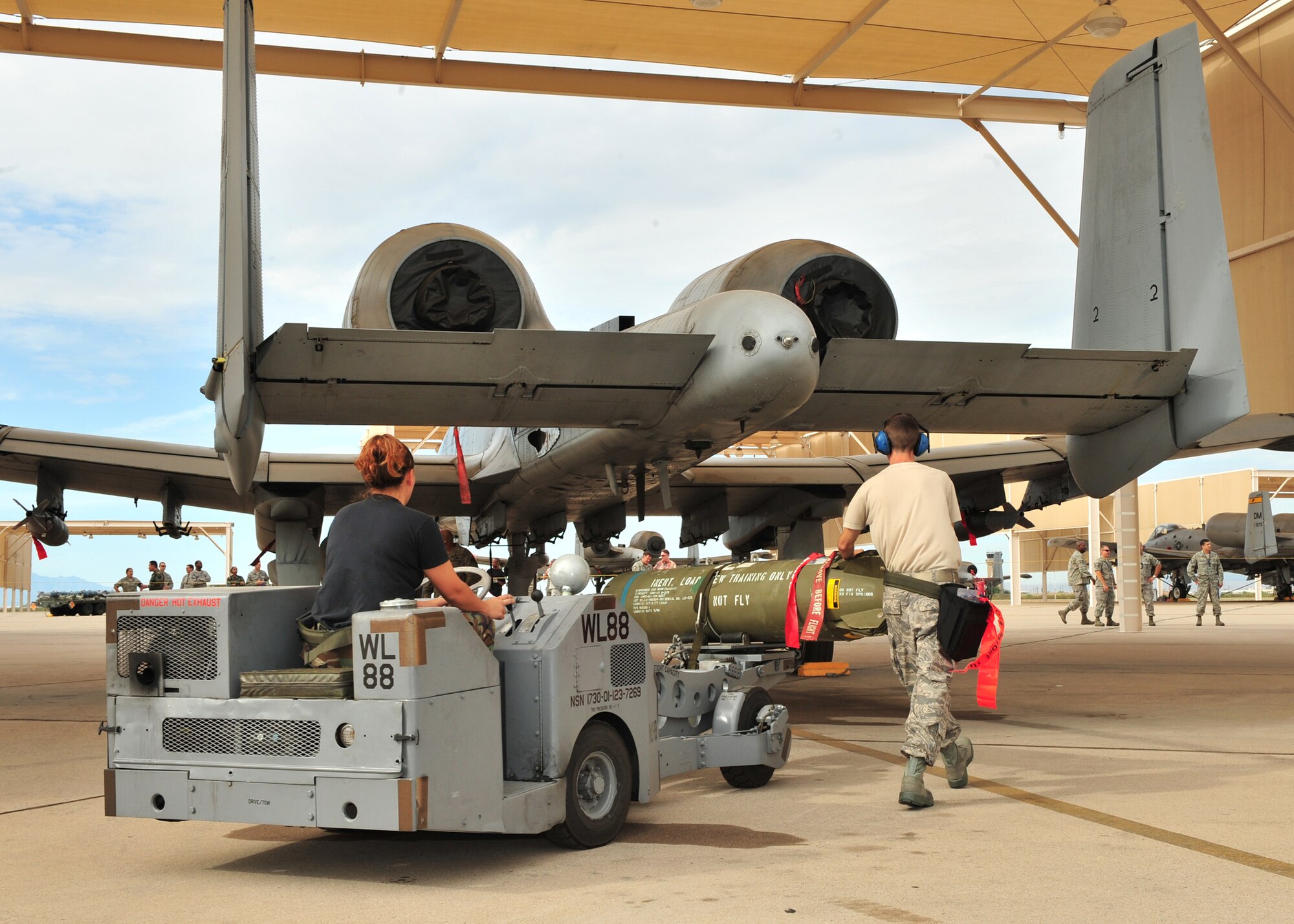 Airman First Class Crystal Simms and Staff Sgt. Brian Marchand of the 355th Aircraft Maintenance Squadron prepare to load a MK-82 bomb onto an A-10 during the Load Crew of the Quarter Competition here, July 24. (U.S. Air Force photo/Senior Airman Noah R. Johnson)