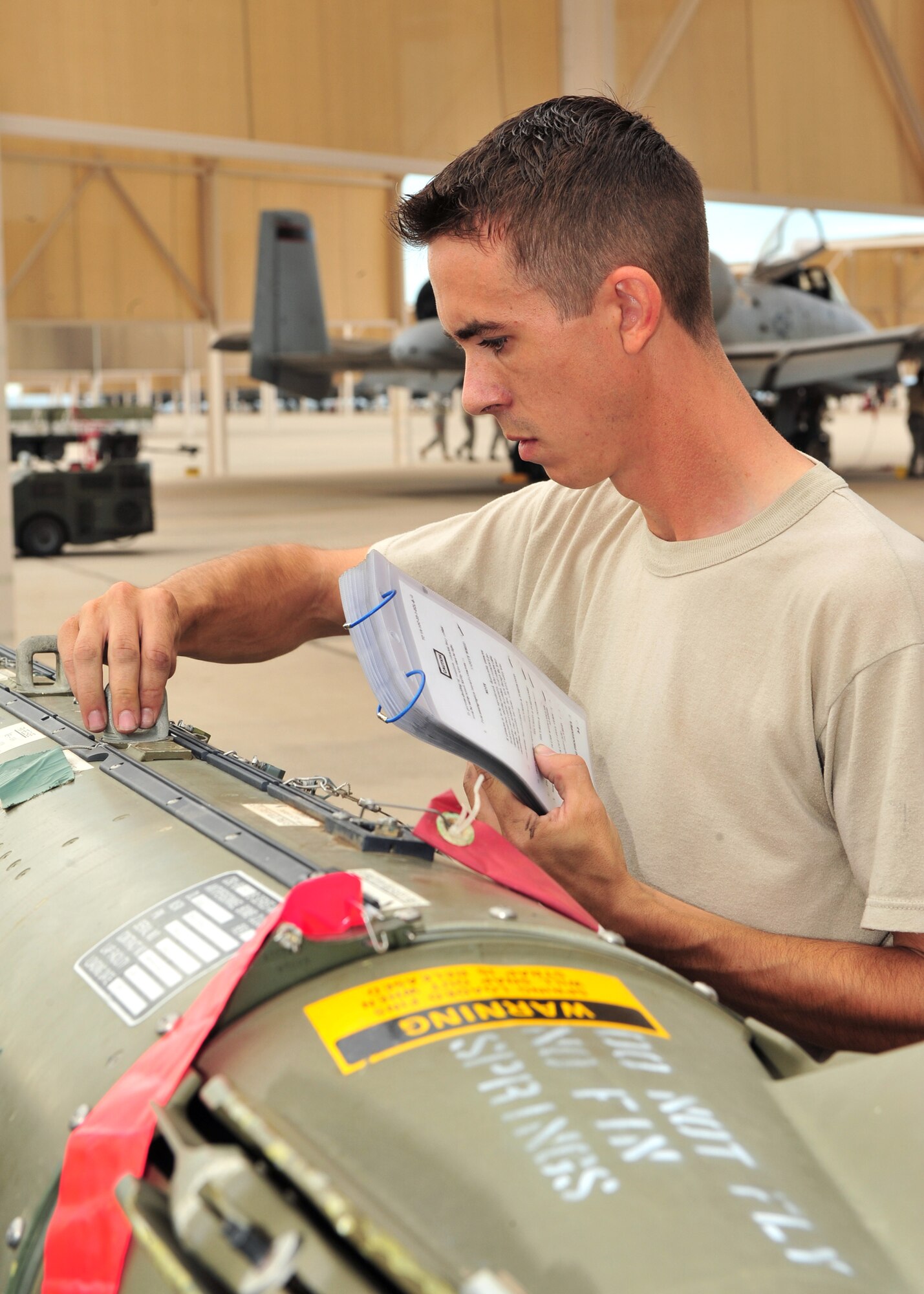 Staff Sgt. Brian Marchand of the 355th Aircraft Maintenance Squadron prepares a MK-82 bomb before loading it onto an A-10 during the Load Crew of the Quarter Competition here, July 24. (U.S. Air Force photo/Senior Airman Noah R. Johnson)