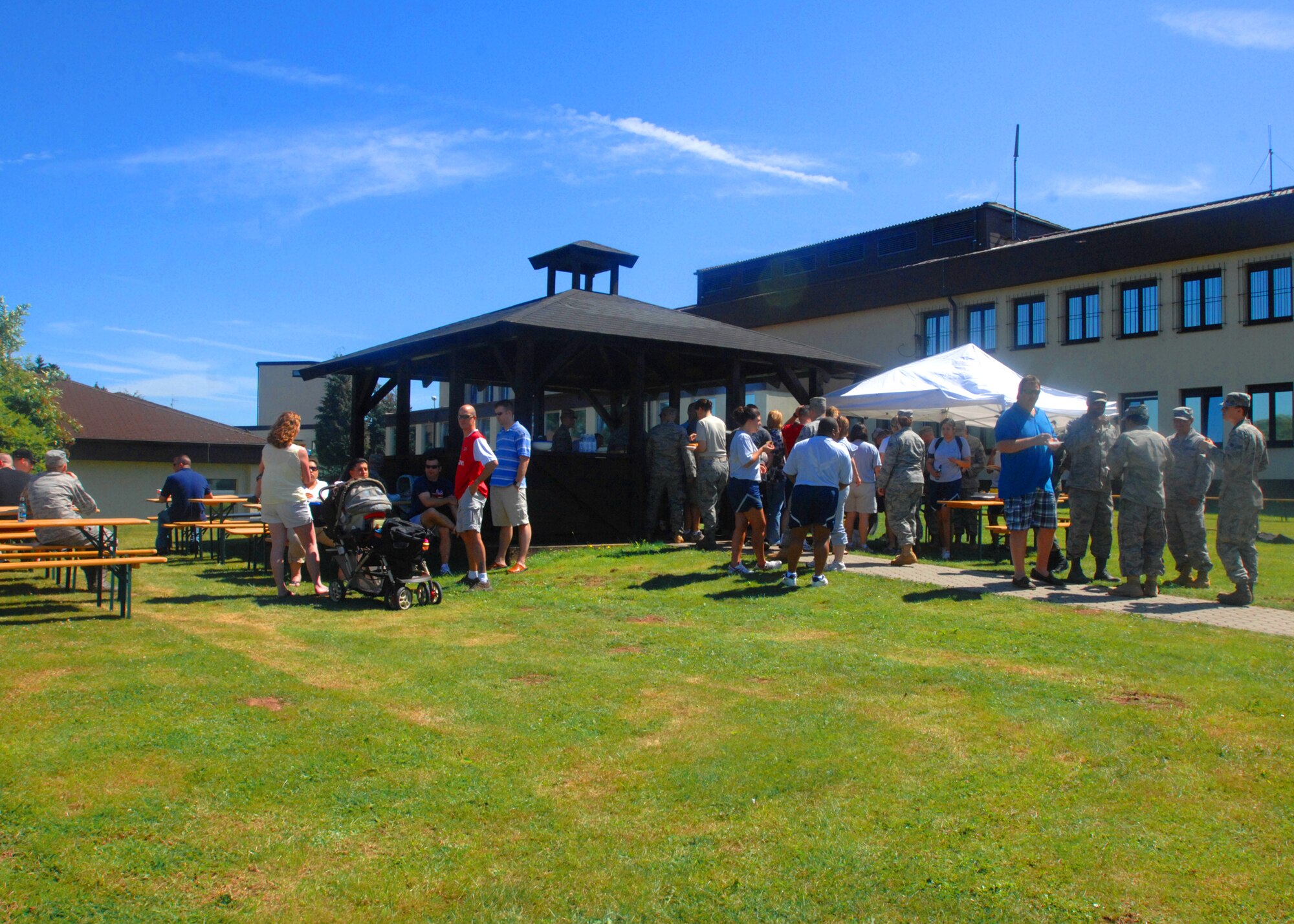 SPANGDAHLEM AIR BASE, Germany -- Members of the 52nd Operational Support Squadron, enjoy a moral picnic July 27 behind 52nd Fighter Wing’s headquarters during the OSS morale picnic.  Once a quarter the 52nd OSS booster club sponsors an event to bring the flights together for a day of friendly competition, food, an inflatable castle and a tug-o-war contest. (U.S. Air Force photo by Senior Airman Jenifer H. Calhoun)