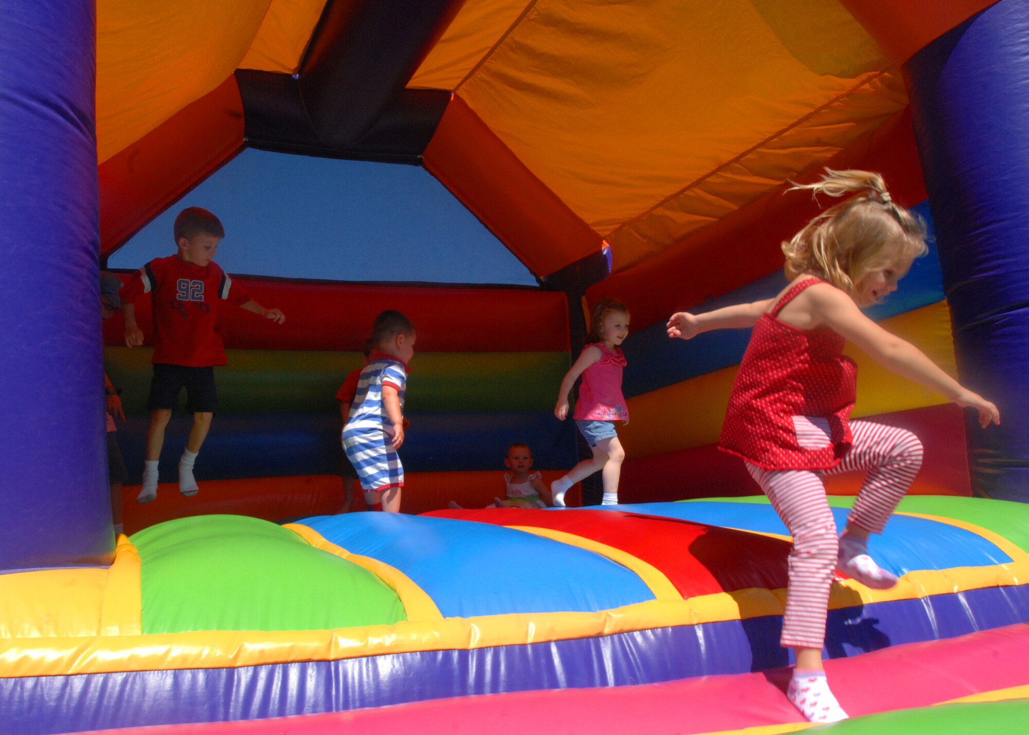 SPANGDAHLEM AIR BASE, Germany -- Children of members of the 52nd Operational Support Squadron play in an inflatable castle July 27 behind the 52nd Fighter Wing’s headquarters during the OSS morale picnic, that included an inflatable castle, hamburgers and refreshments, as well as a tug-o-war contest. The event was sponsored by the OSS booster club. (U.S. Air Force photo by Senior Airman Jenifer H. Calhoun)