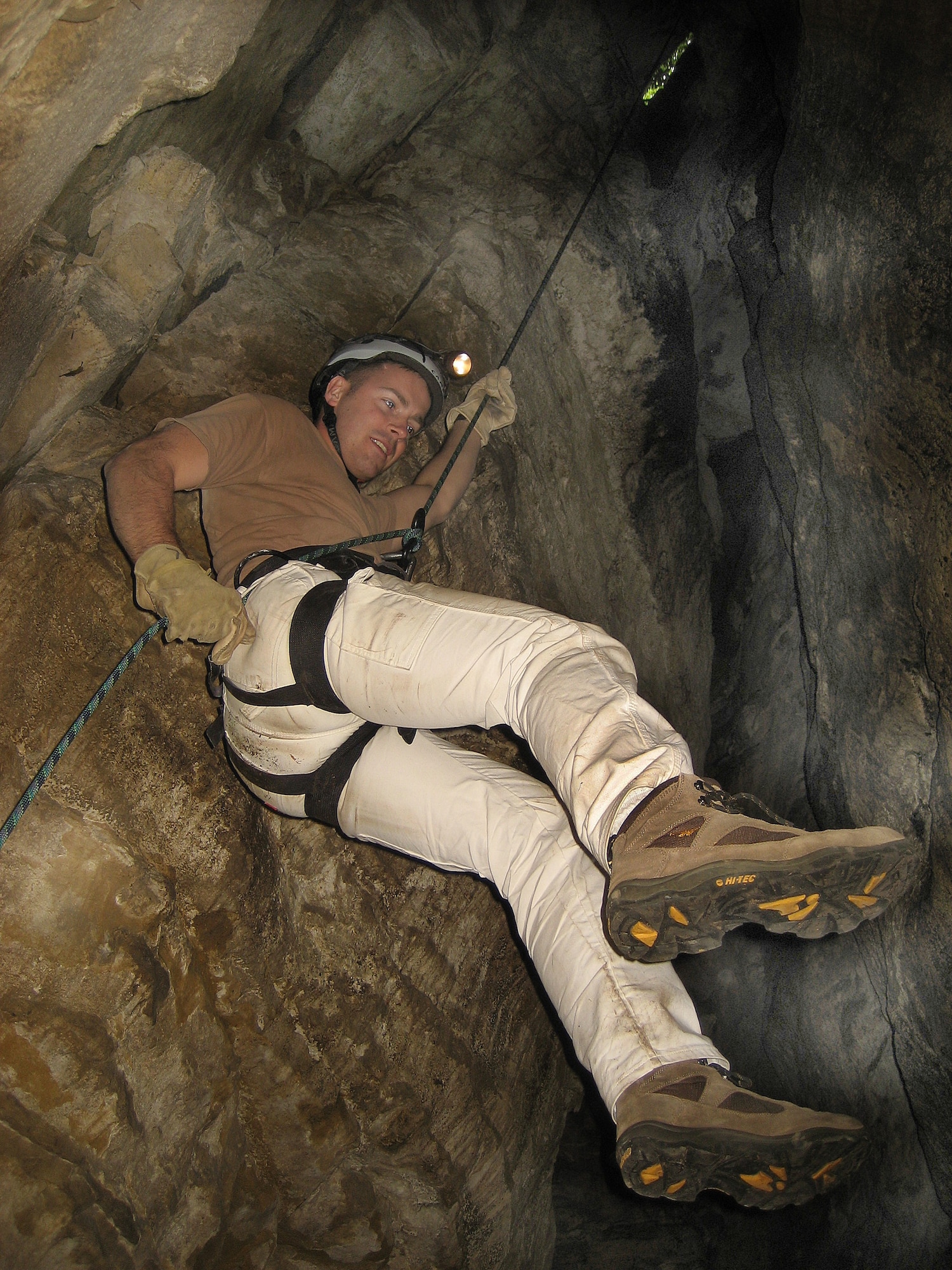 SPANGDAHELM AIR BASE, Germany -- Capt. Jared Ferneau, 52nd Fighter Wing Plans and Programs, rappels into a cave during an Outdoor Recreation daytrip. Capt. Ferneau was one of approximately 25 Sabers who ventured to Luxembourg to crawl through and descend into caves, which were dark enough to require a hardhat light. Upcoming Outdoor Recreation caving and rappelling trips are scheduled for Aug. 9 and Sept. 12. (U.S. Air Force photo by 1st Lt. Kathleen Polesnak)