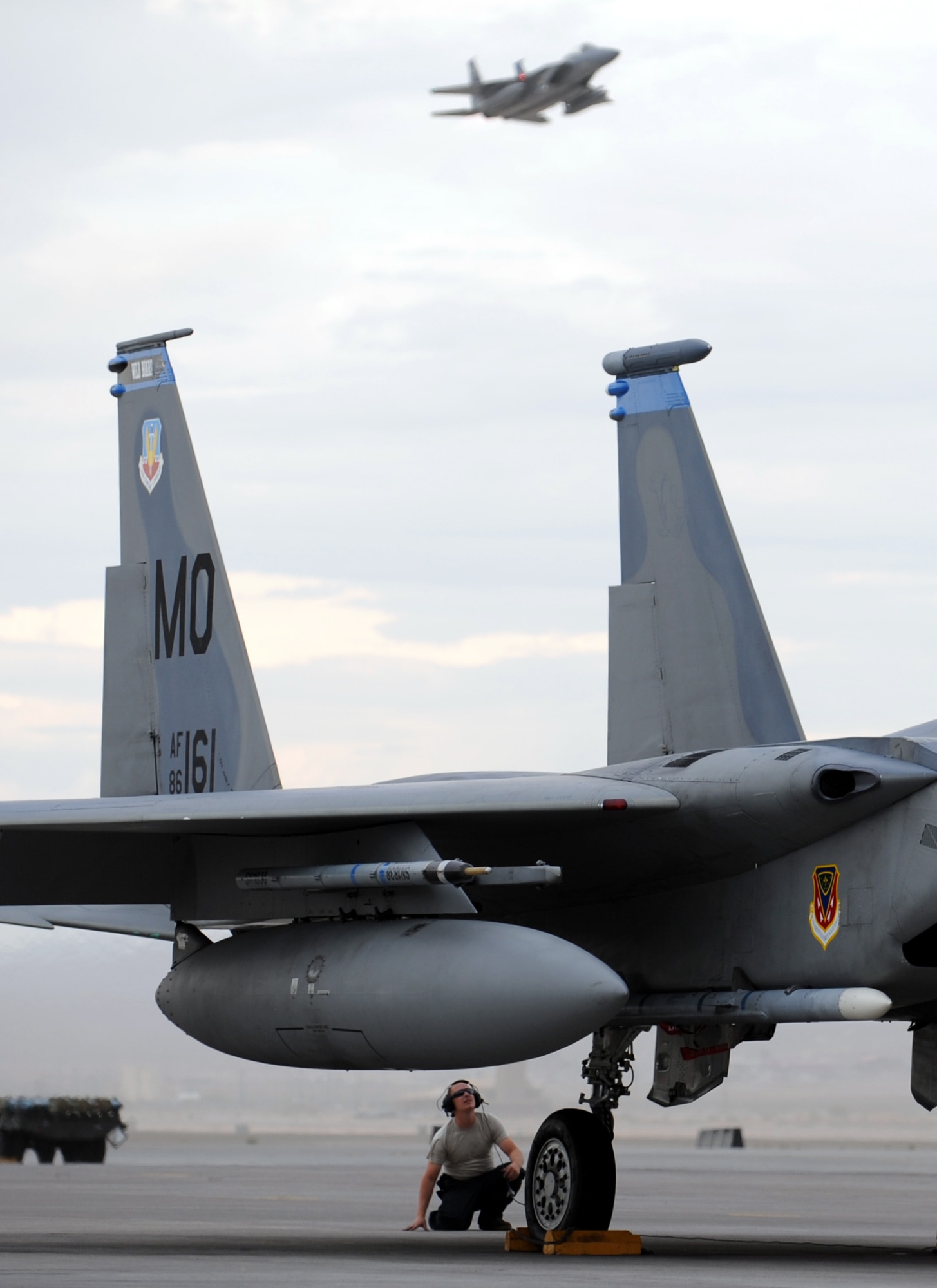 NELLIS AIR FORCE BASE, Nev. -- Senior Airman Wayne Baker, a crew chief from 366th Aircraft Maintenance Squadron, Mountain Home Air Force Base, Idaho, performs a pre-flight check on an F-15C Eagle July 23 during Red Flag 09-4. Red Flag is a realistic combat training exercise involving the air forces of the United States and its allies. The exercise is conducted on the 15,000-square-mile Nevada Test and Training Range, north of Las Vegas. (U.S. Air Force photo by Airman 1st Class Brett Clashman)