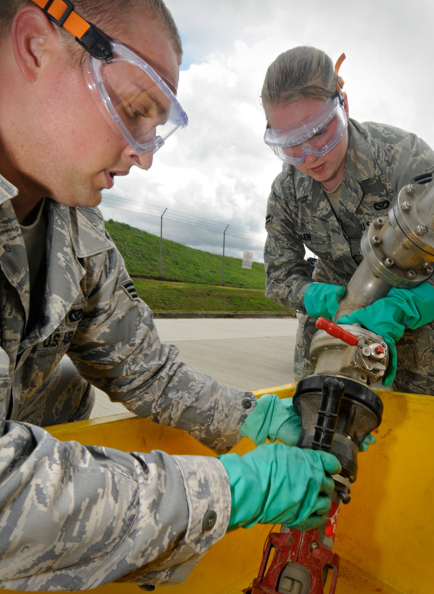 SPANGDAHLEM AIR BASE, Germany – Senior Airman Ivan Alandzak and Airman 1st Class Jennea Allen, 52nd Civil Engineer Squadron, replace a single point nozzle over a drip-pan on one of Spangdahlem Air Base’s truck refueling stands July 23. The 52nd CES Liquid Fuels Flight changes and repairs the nozzles in the event there is damage or a leak. The liquid fuels flight manages 2,300 meters of fuel pipeline, 23 underground fuel tanks and 8.2 million gallons of JP-8. (U.S. Air Force photo by Senior Airman Benjamin Wilson)
