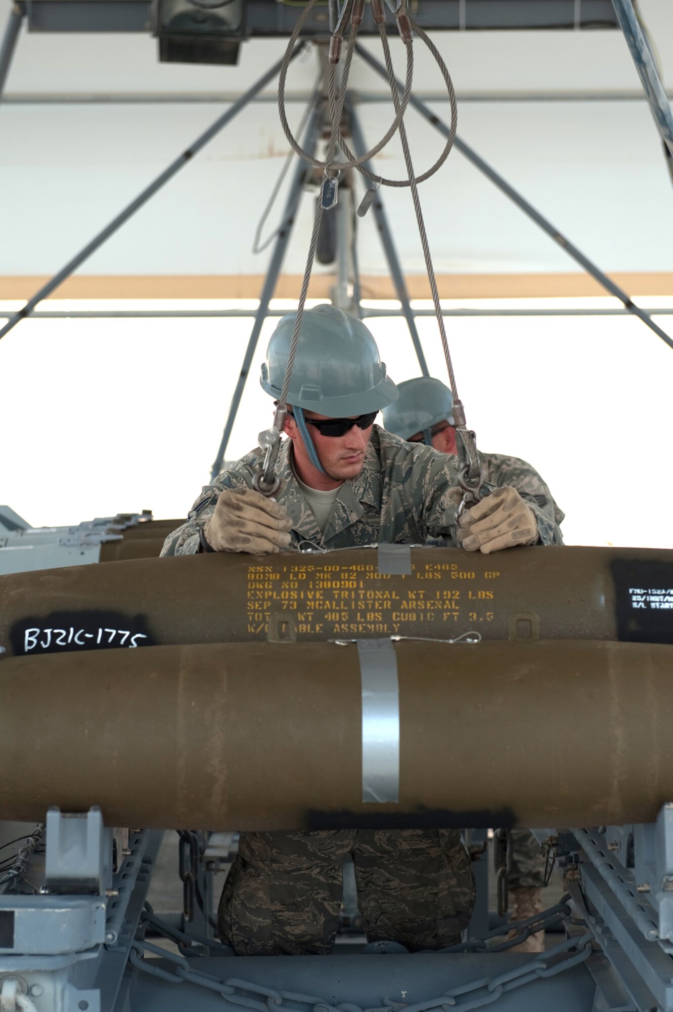 Senior Airman James Deason, 379th Expeditionary Maintenance Squadron conventional maintenance crew chief, secures GBU-38’s for transportation to a ready line in preparation for loading an aircraft.  Airman Deason is a native of Dayton, Texas and is deployed from Dyess Air Force Base, Texas, in support of Operations Iraqi and Enduring Freedom. (U.S. Air Force Photo/Staff Sgt. Robert Barney)