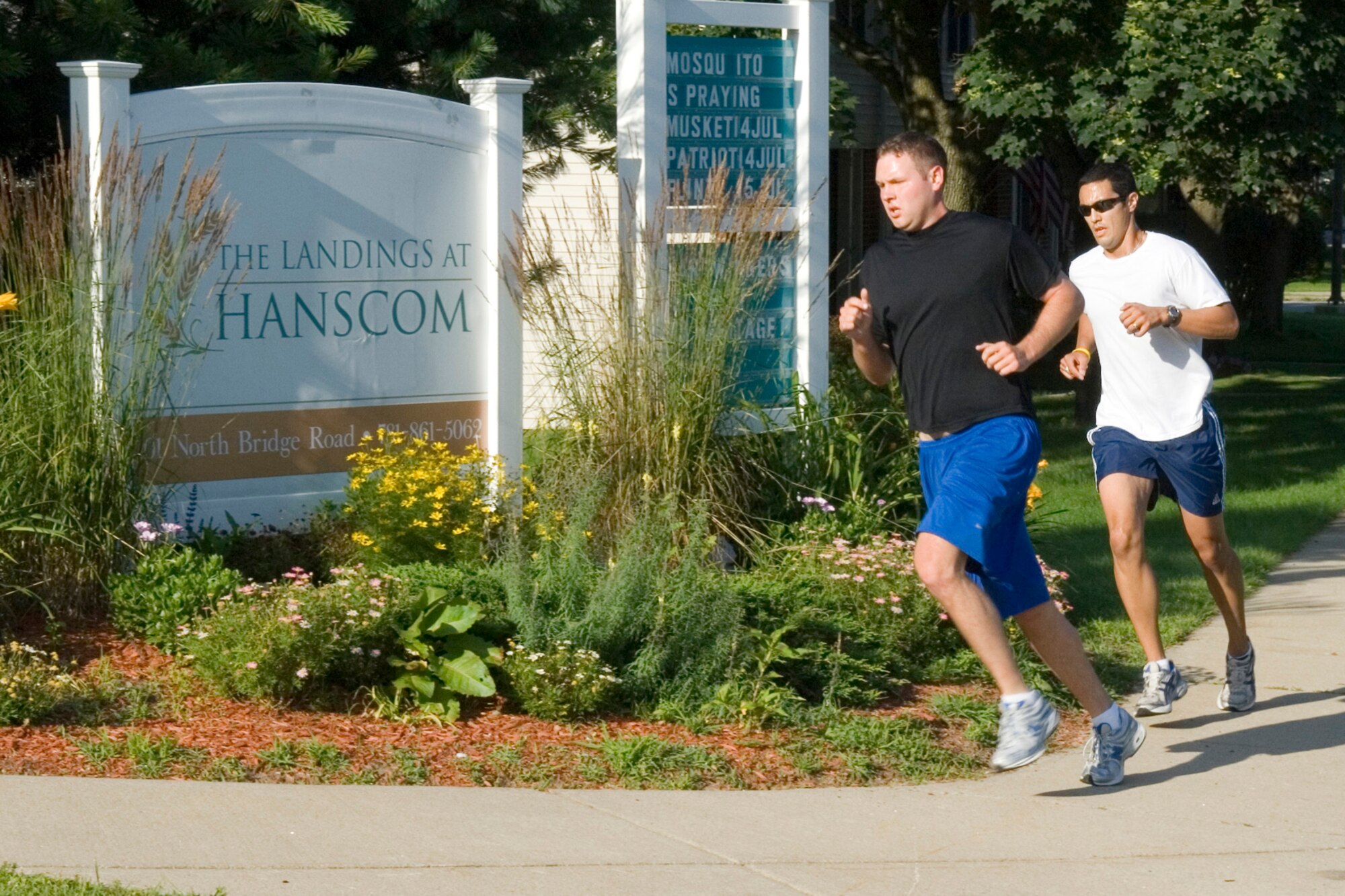 2nd Lt. Evan Dadosky, Electronic Systems Center commander's action office, and Staff Sgt. David Warszawski, ESC executive services, round a hard right turn during the Firecracker 5K Run on July 15. (U.S. Air Force photo by Rick Berry)
